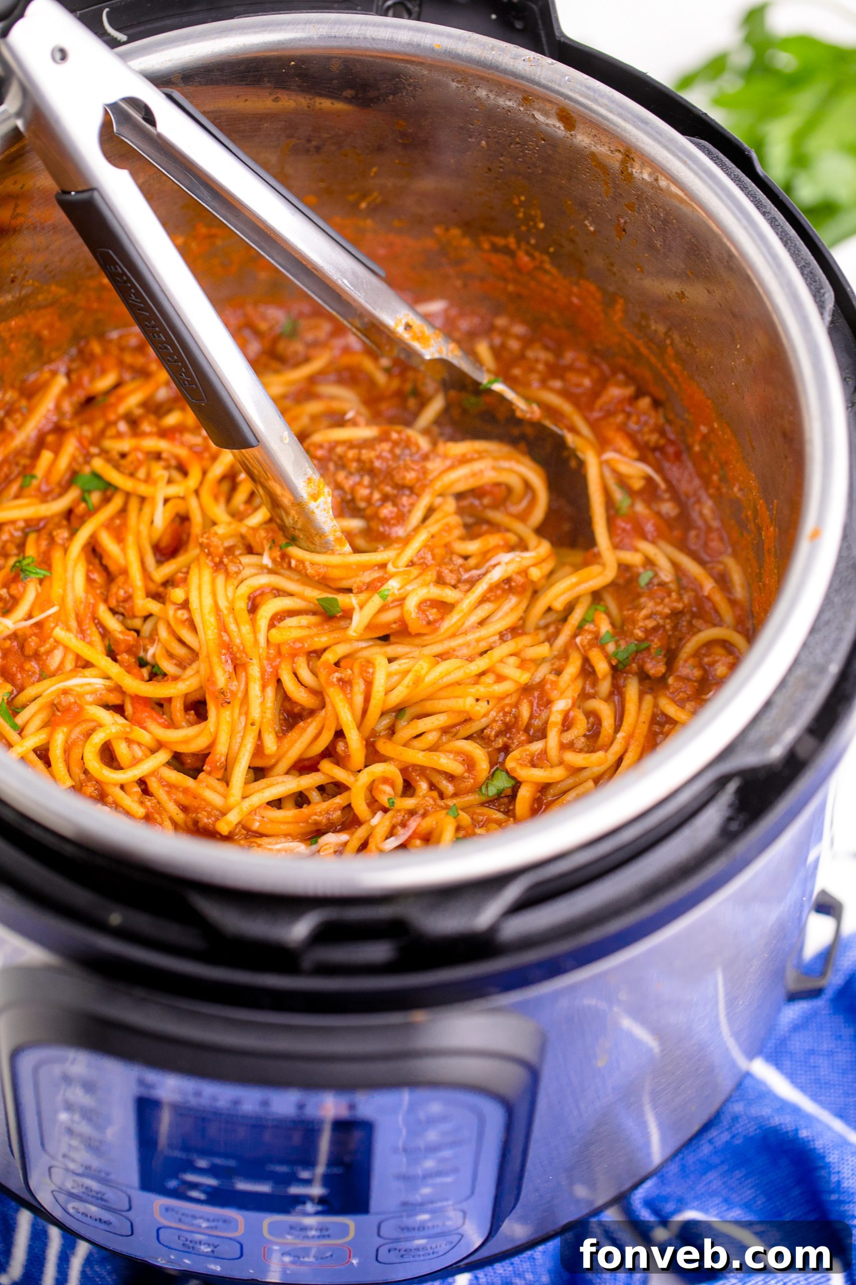 Instant Pot Spaghetti inthe instant pot being mixed with tongs