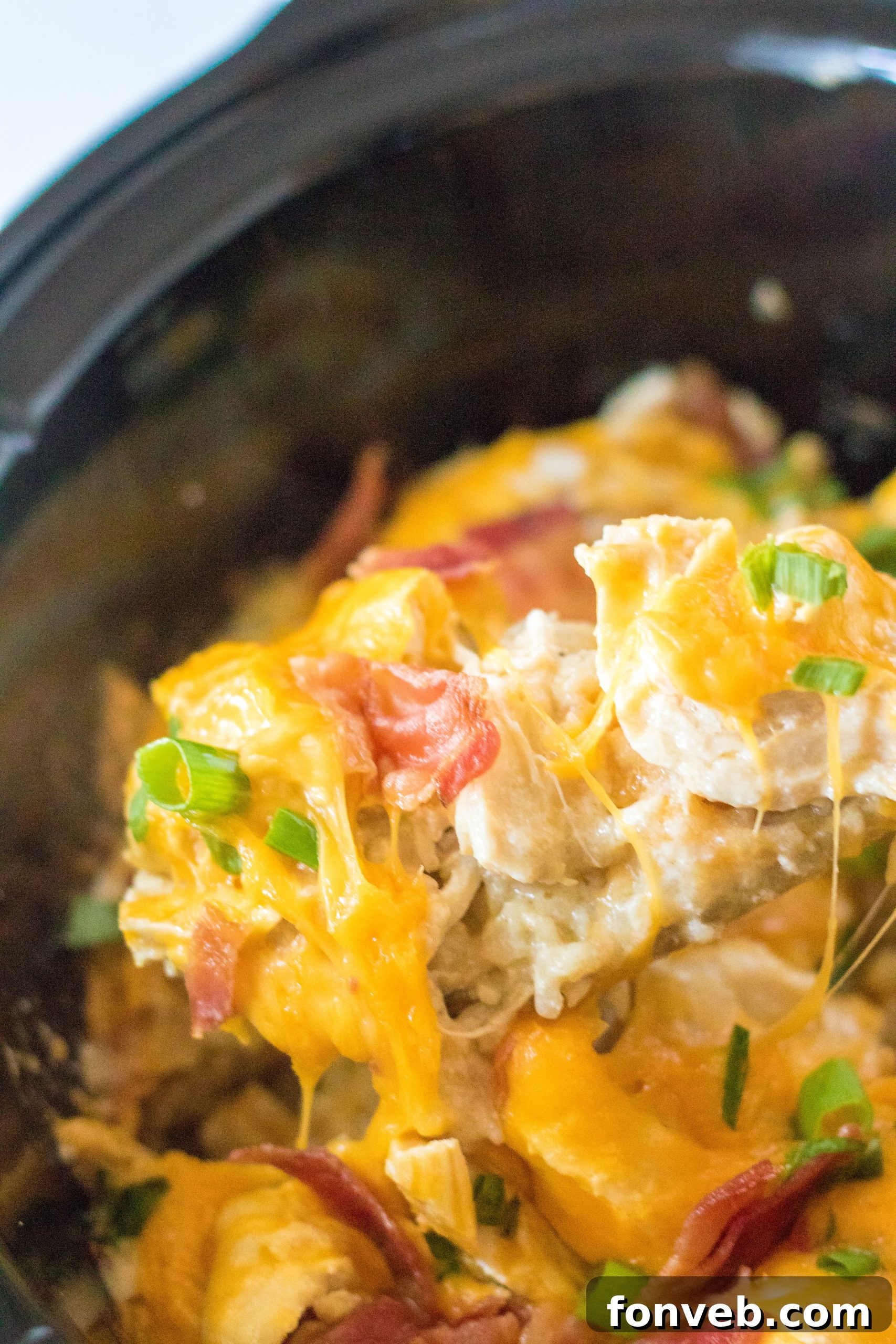 Tater Tot Casserole in the crock pot, perfectly golden and cheesy