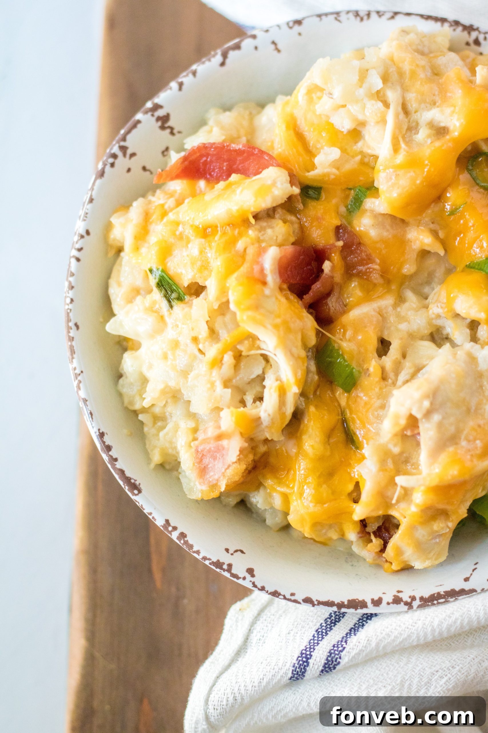 Tater Tot Casserole in a white bowl, close up of the texture