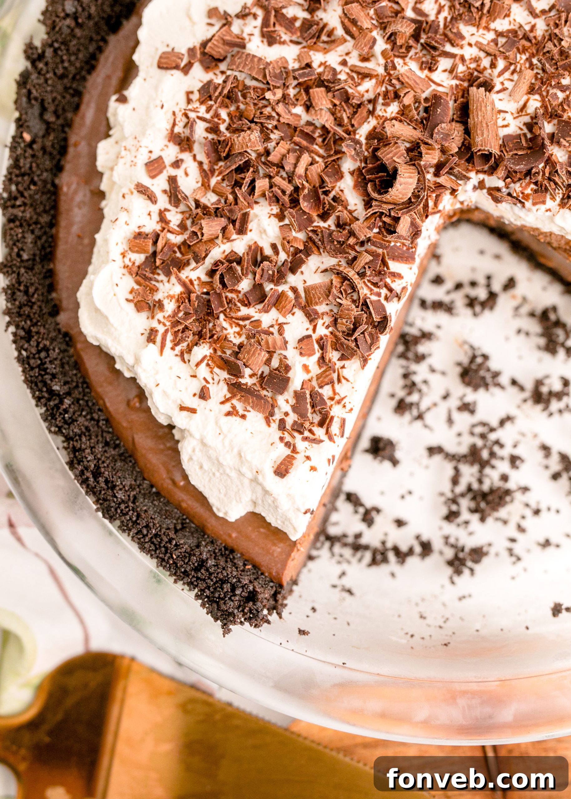 Velvet Chocolate Dream 12 Chocolate Cream Pie topped with whipped cream and chocolate shavings in a white pie dish, overhead shot