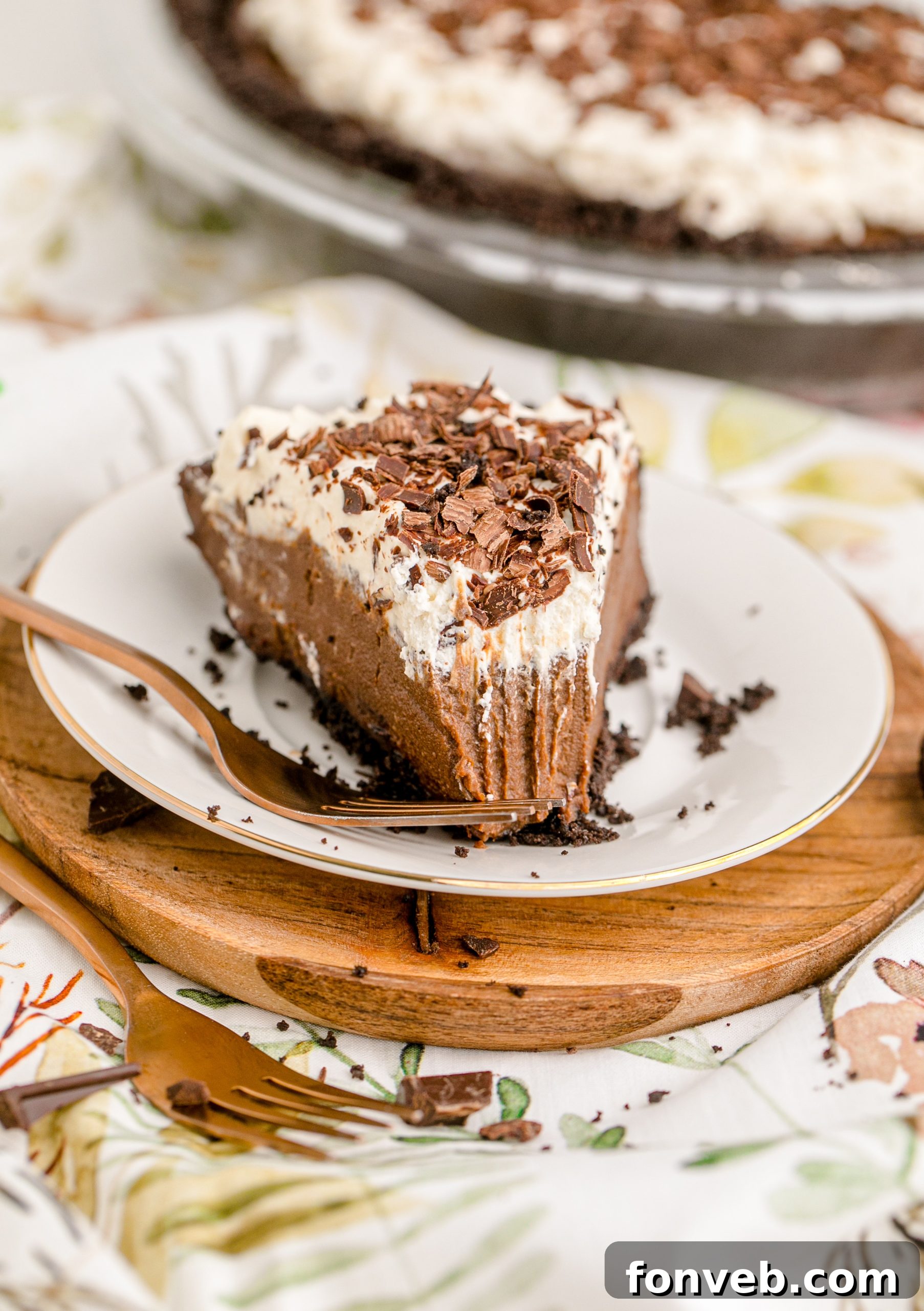 Velvet Chocolate Dream 13 A slice of Chocolate Cream Pie topped with whipped cream and chocolate shavings on a white plate
