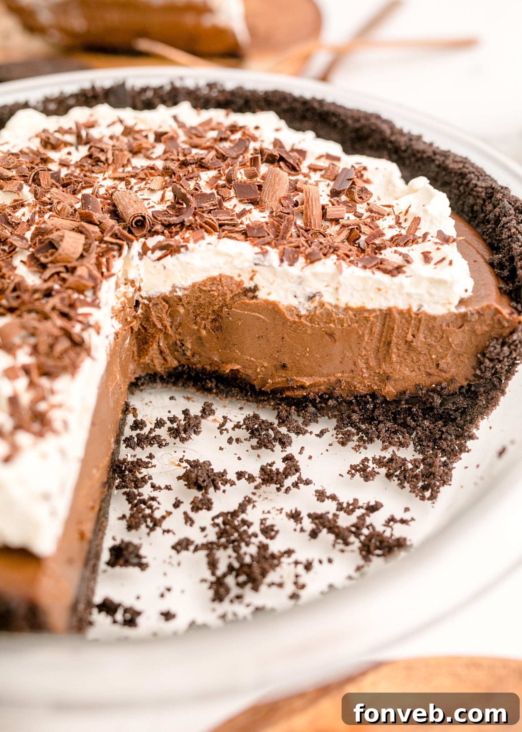 Velvet Chocolate Dream 14 Chocolate Cream Pie topped with whipped cream and chocolate shavings in a white pie plate