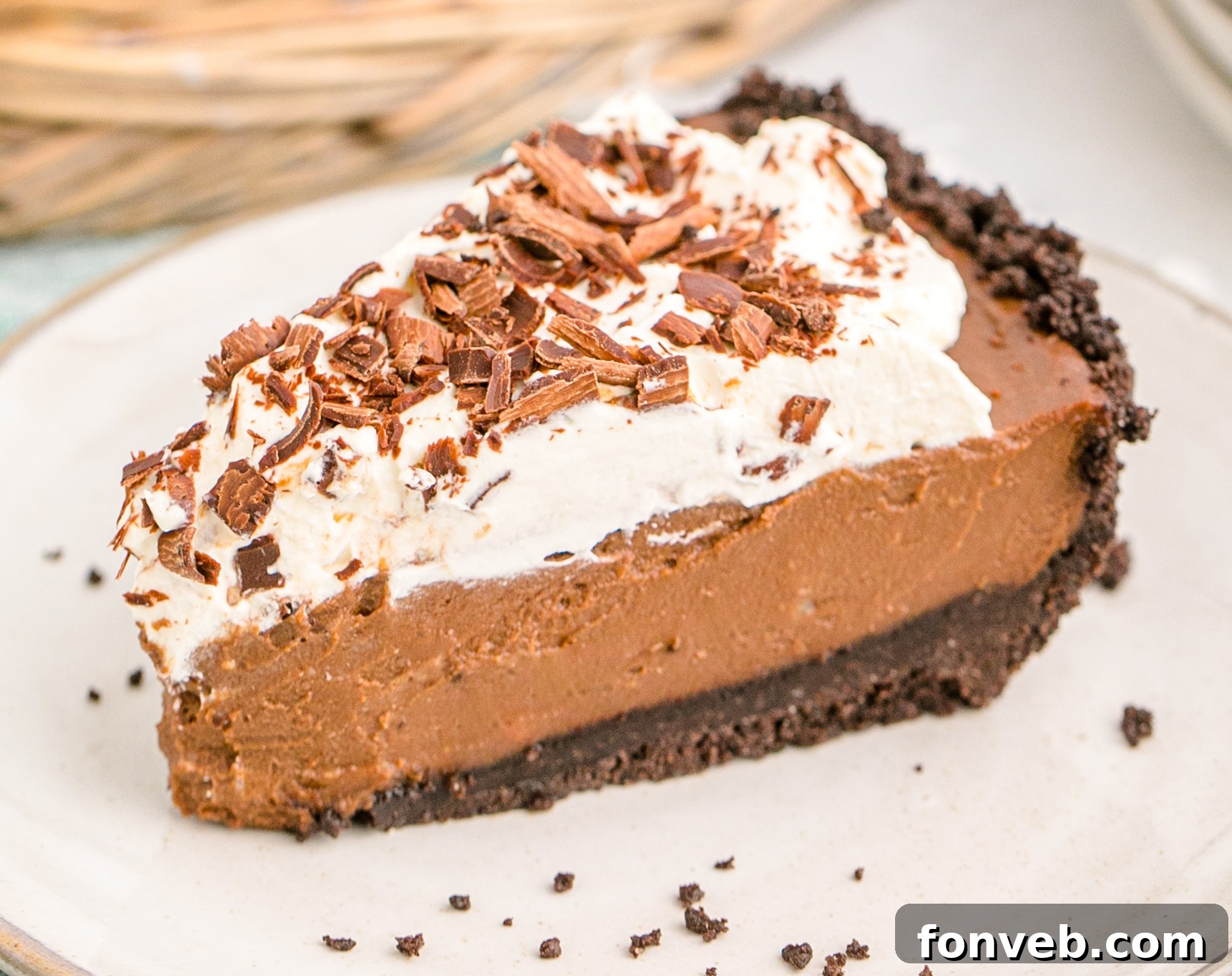 Velvet Chocolate Dream 22 Chocolate Cream Pie topped with whipped cream and chocolate shavings on a white plate, perfect for serving