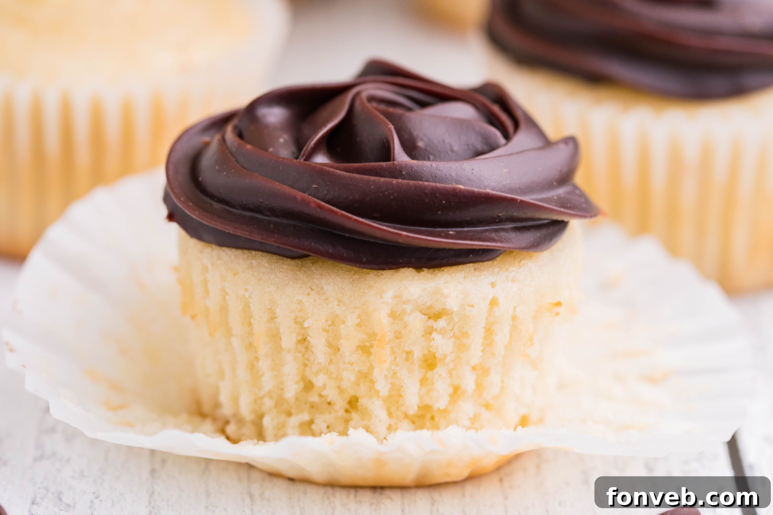 side shot of Boston Cream Cupcakes on a white counter