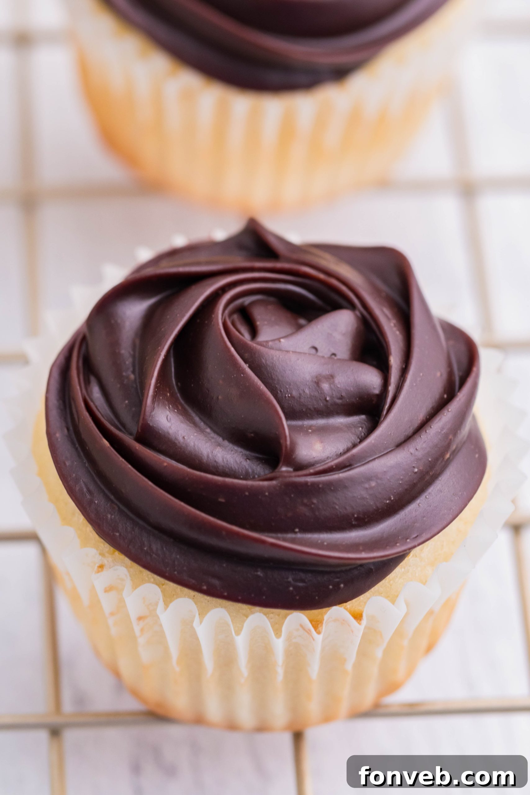 overhead shot of Boston Cream Cupcakes on a cooling metal rack