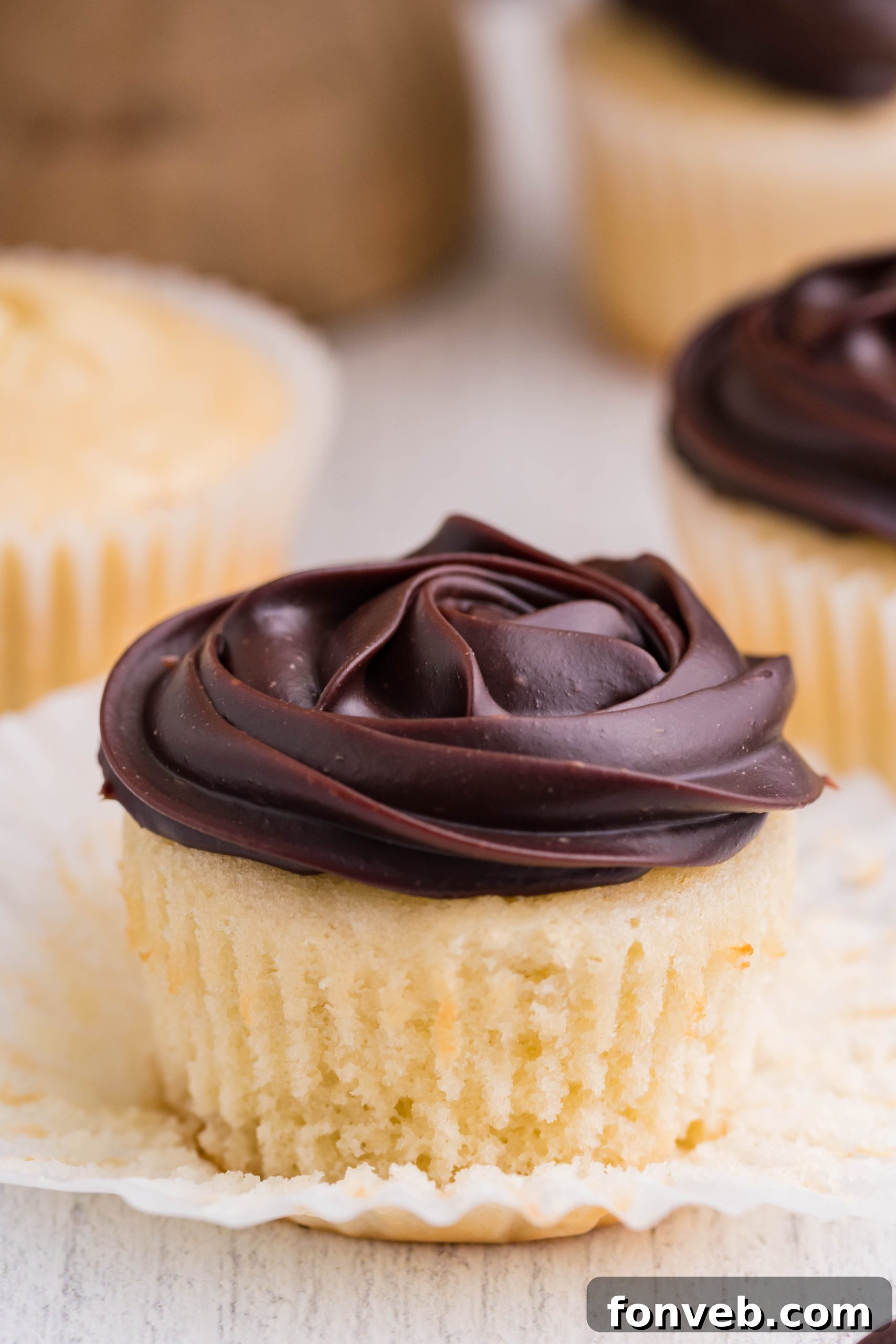 side shot of Boston Cream Cupcakes on a white counter
