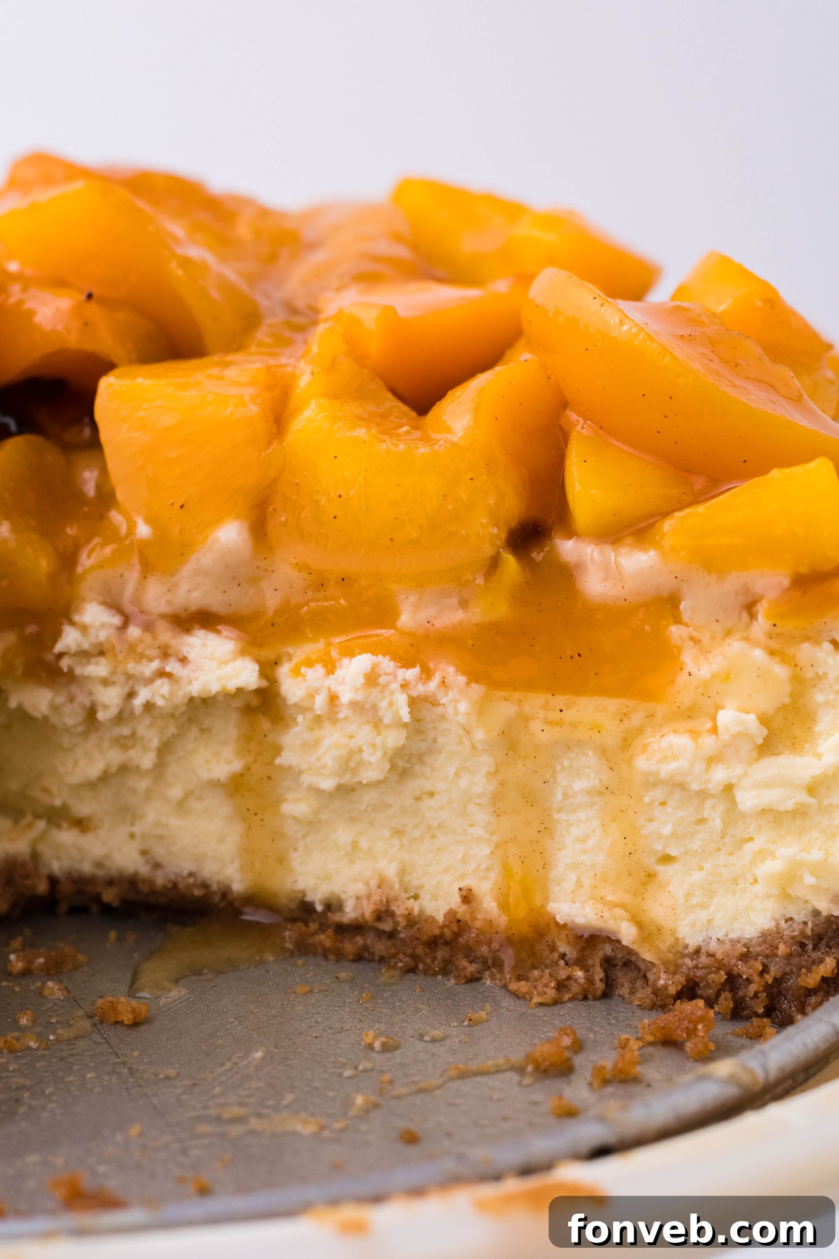 Peach Cobbler Cheesecake in a springform baking pan, ready for the oven.