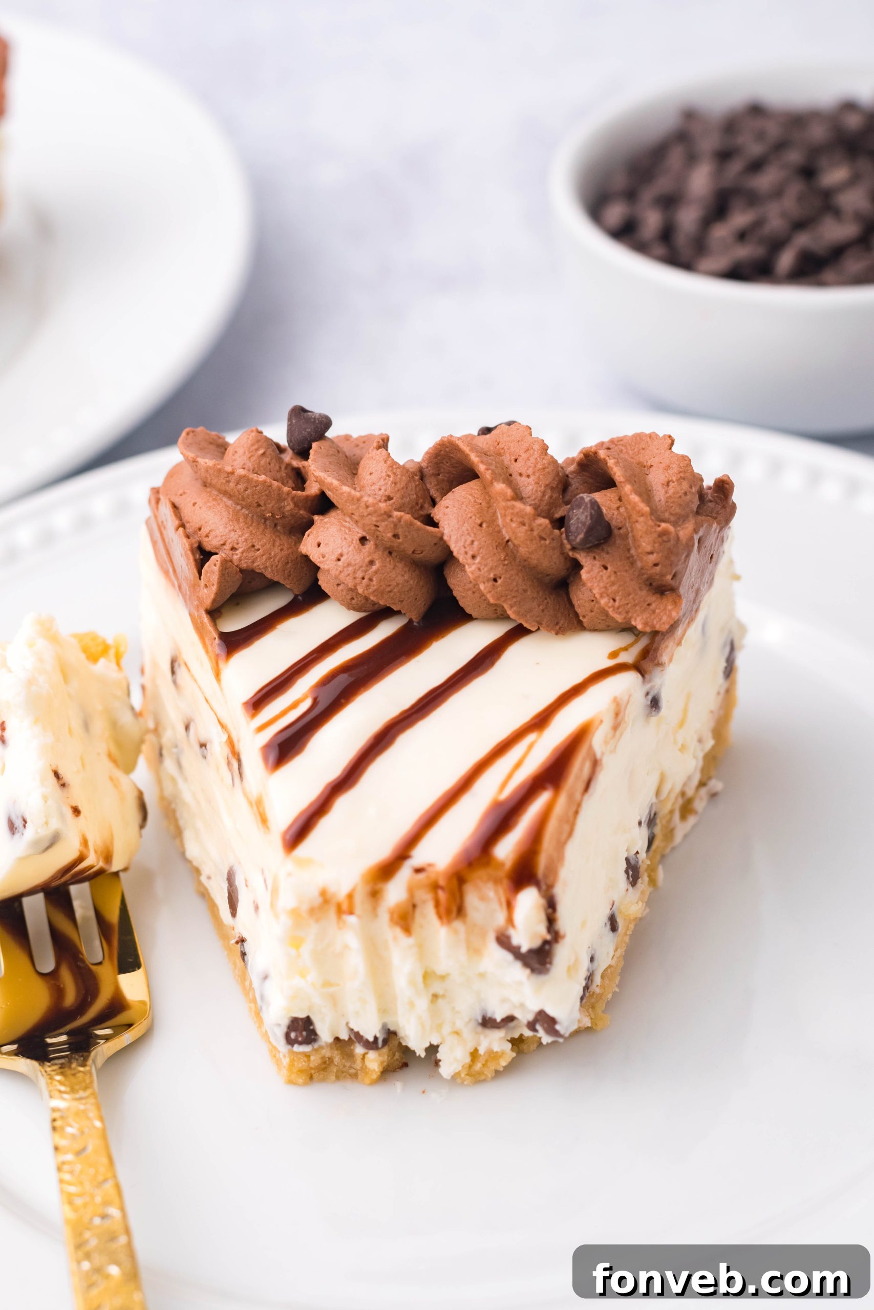 Chocolate Chip Cheesecake on a white plate with a bite taken out overhead angle