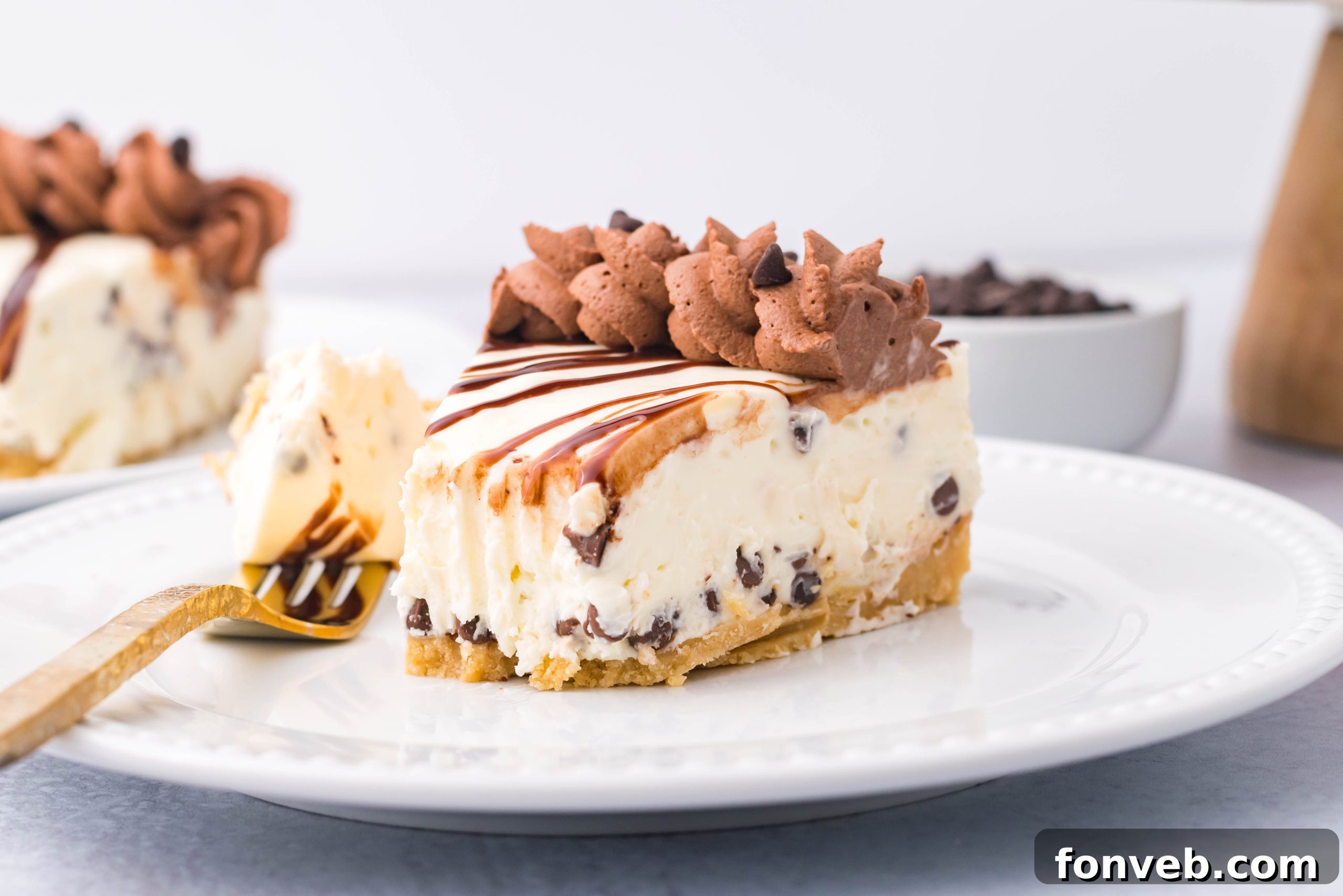 Chocolate Chip Cheesecake on a white plate with a bite taken out