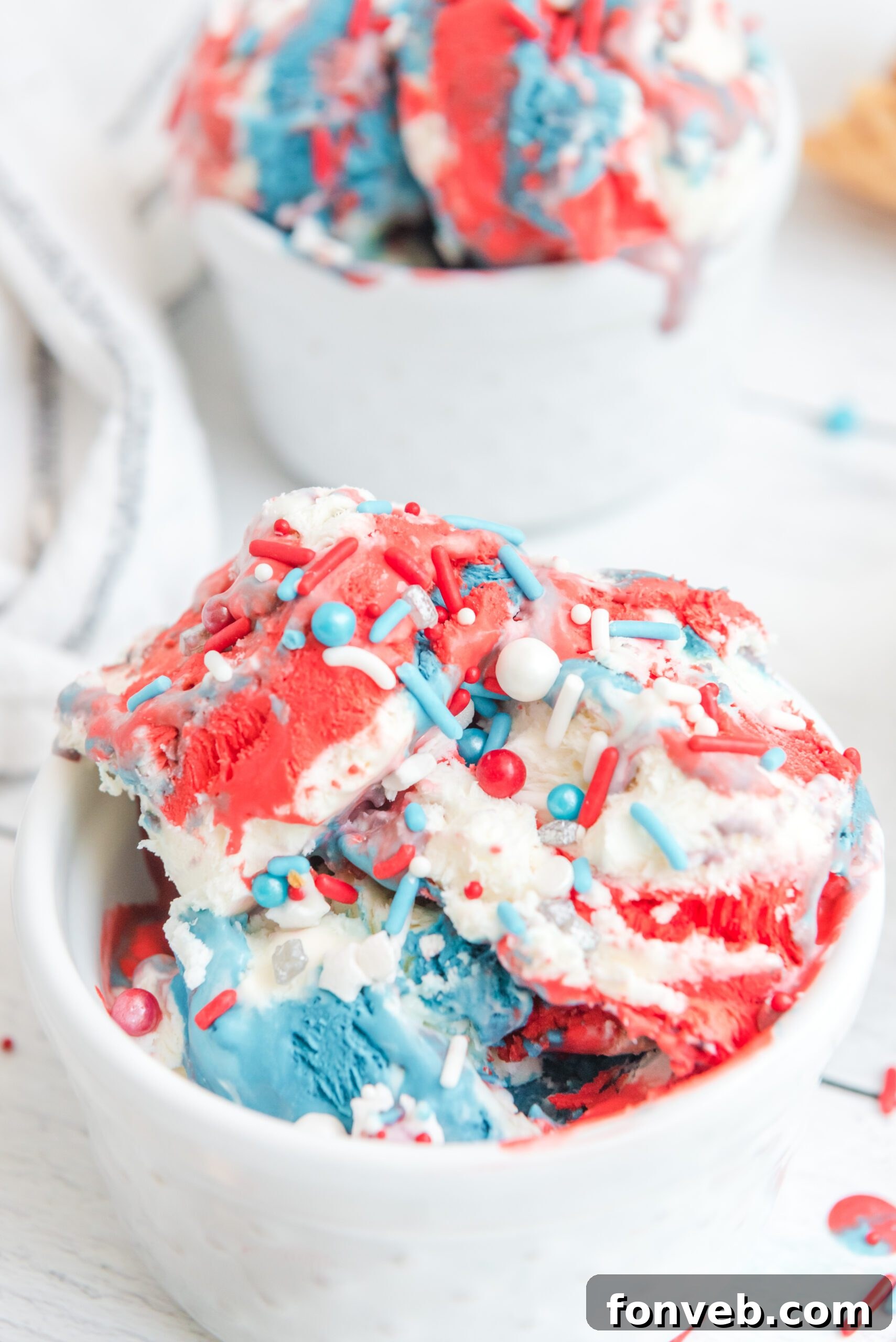 Red, White & Blue Ice Cream in a white bowl with patriotic sprinkles on top