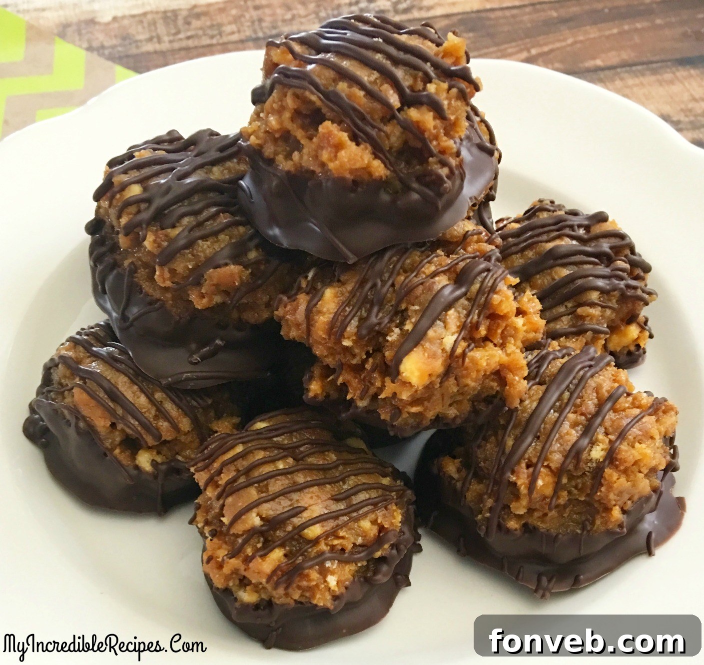 A white plate filled to the brim with Samoa Bites, showcasing a delightful assortment of these chocolate-coated, caramel-drizzled treats.