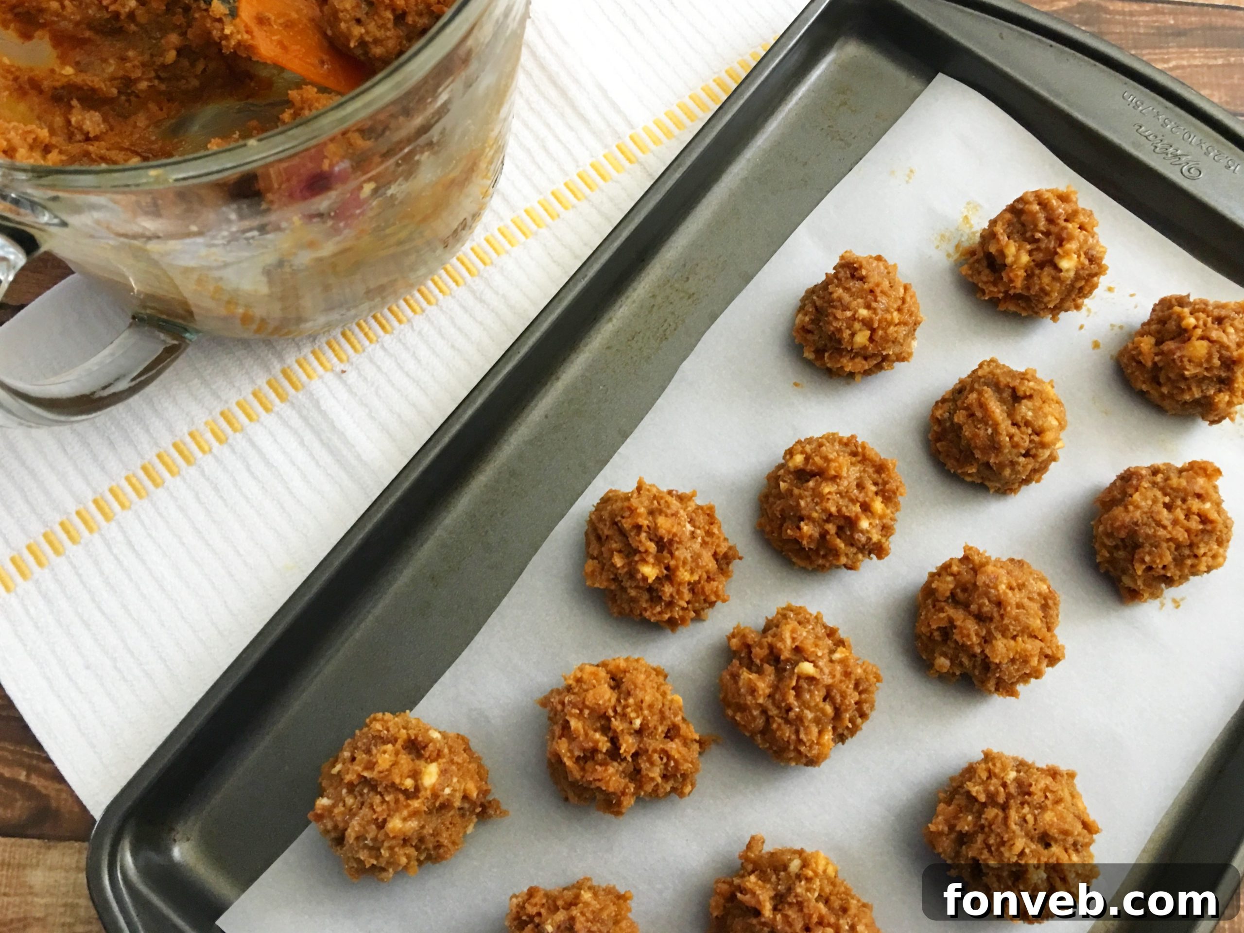 Samoa Bites, shaped and ready for chocolate coating, resting on a parchment paper-lined baking sheet before freezing.