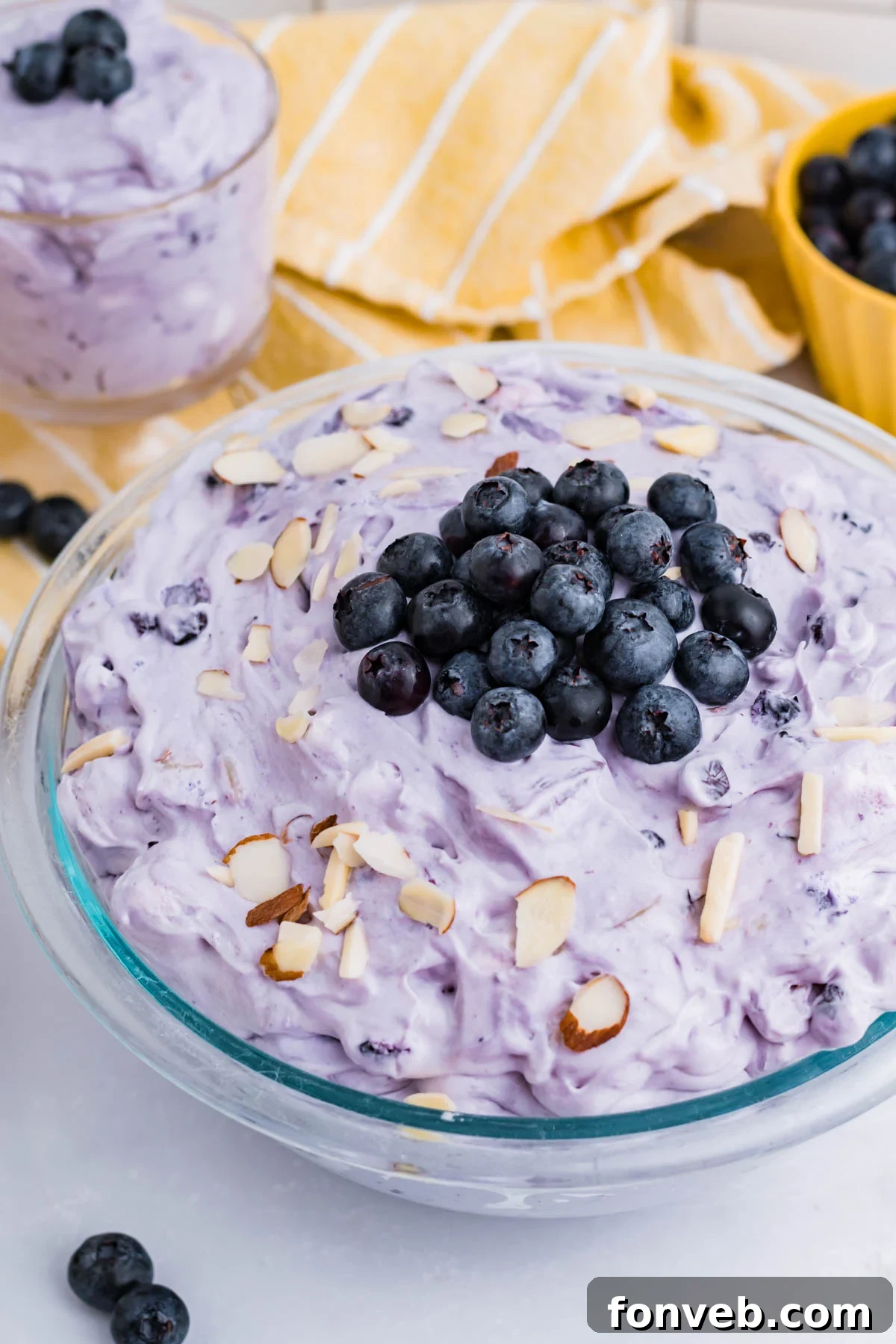 Blueberry Fluff Salad in a clear glass serving bowl overhead shot