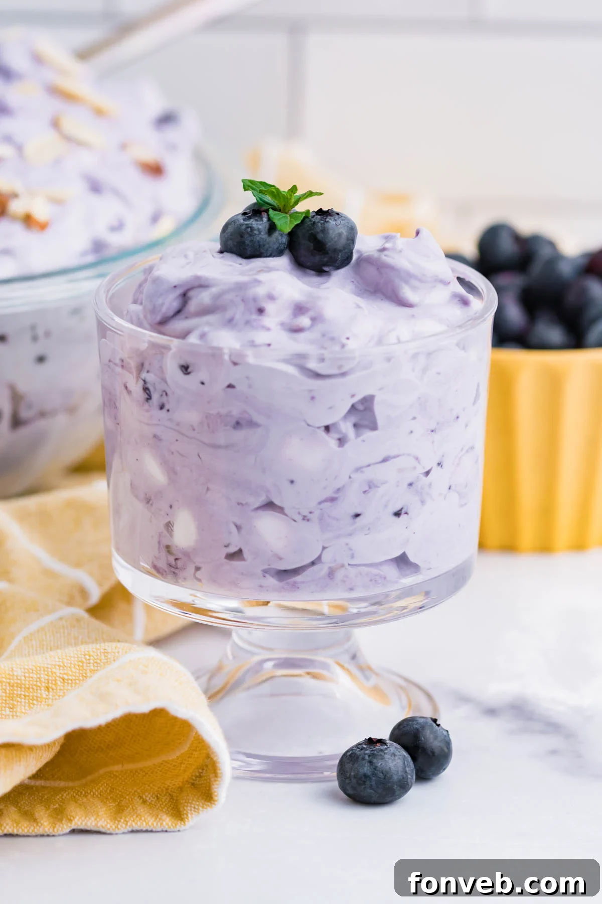 Blueberry Fluff Salad in a clear glass mini trifle side angle
