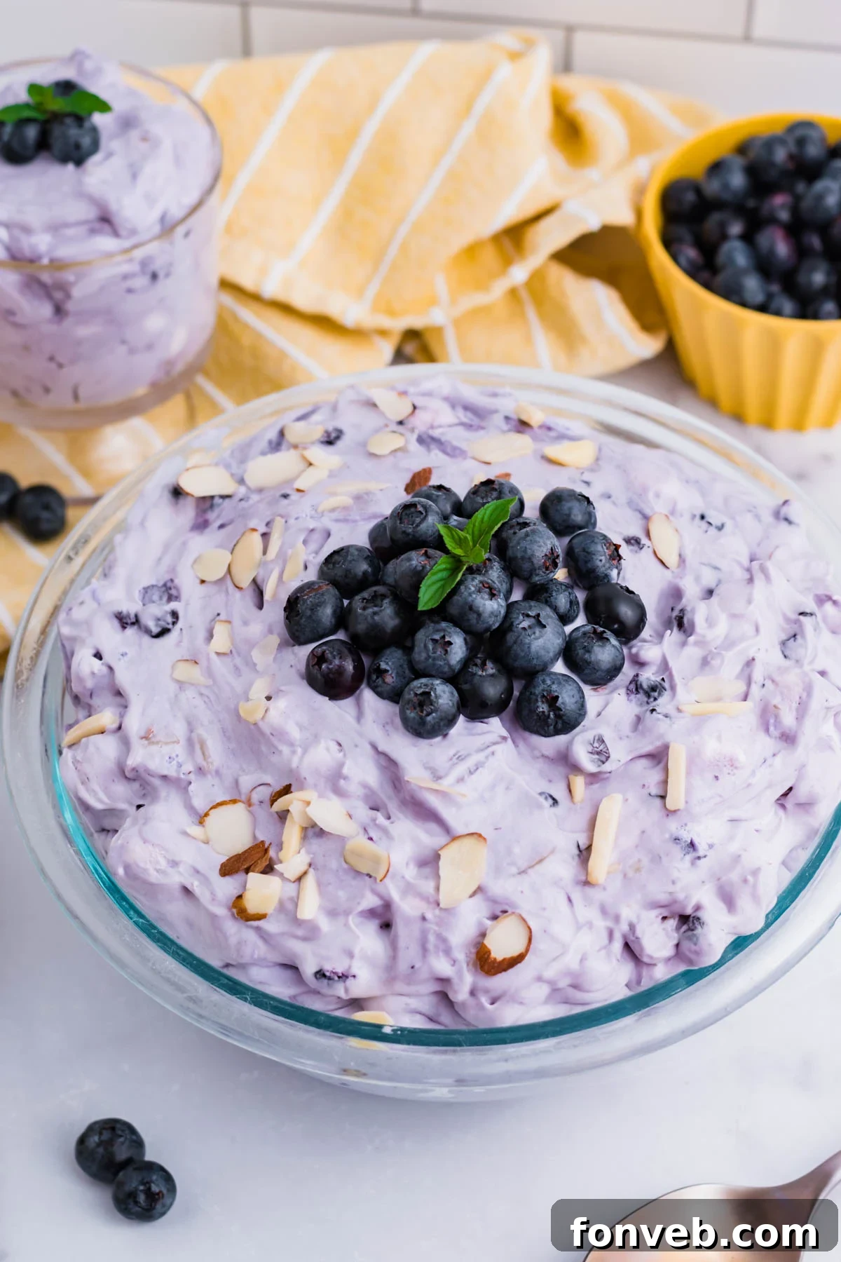 Blueberry Fluff Salad in a clear glass serving bowl