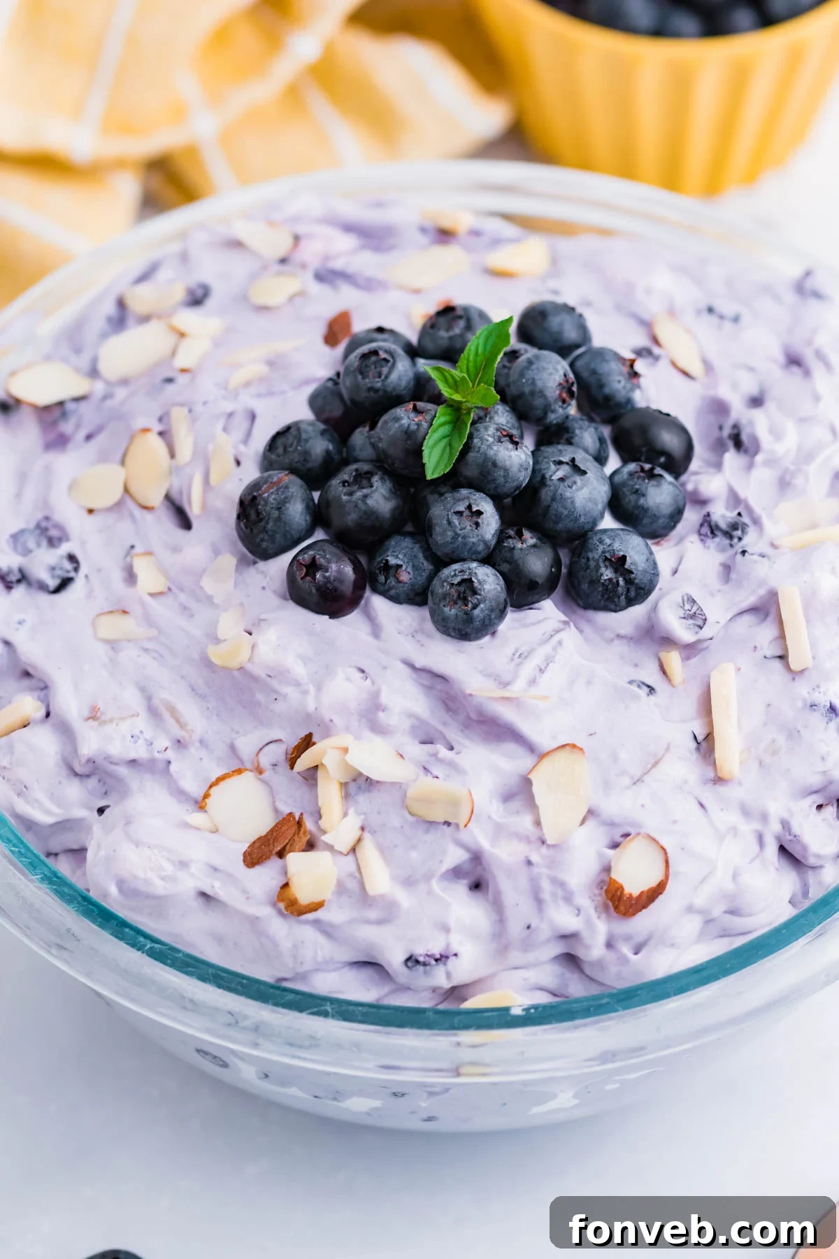 Blueberry Fluff Salad in a clear glass serving bowl overhead shot
