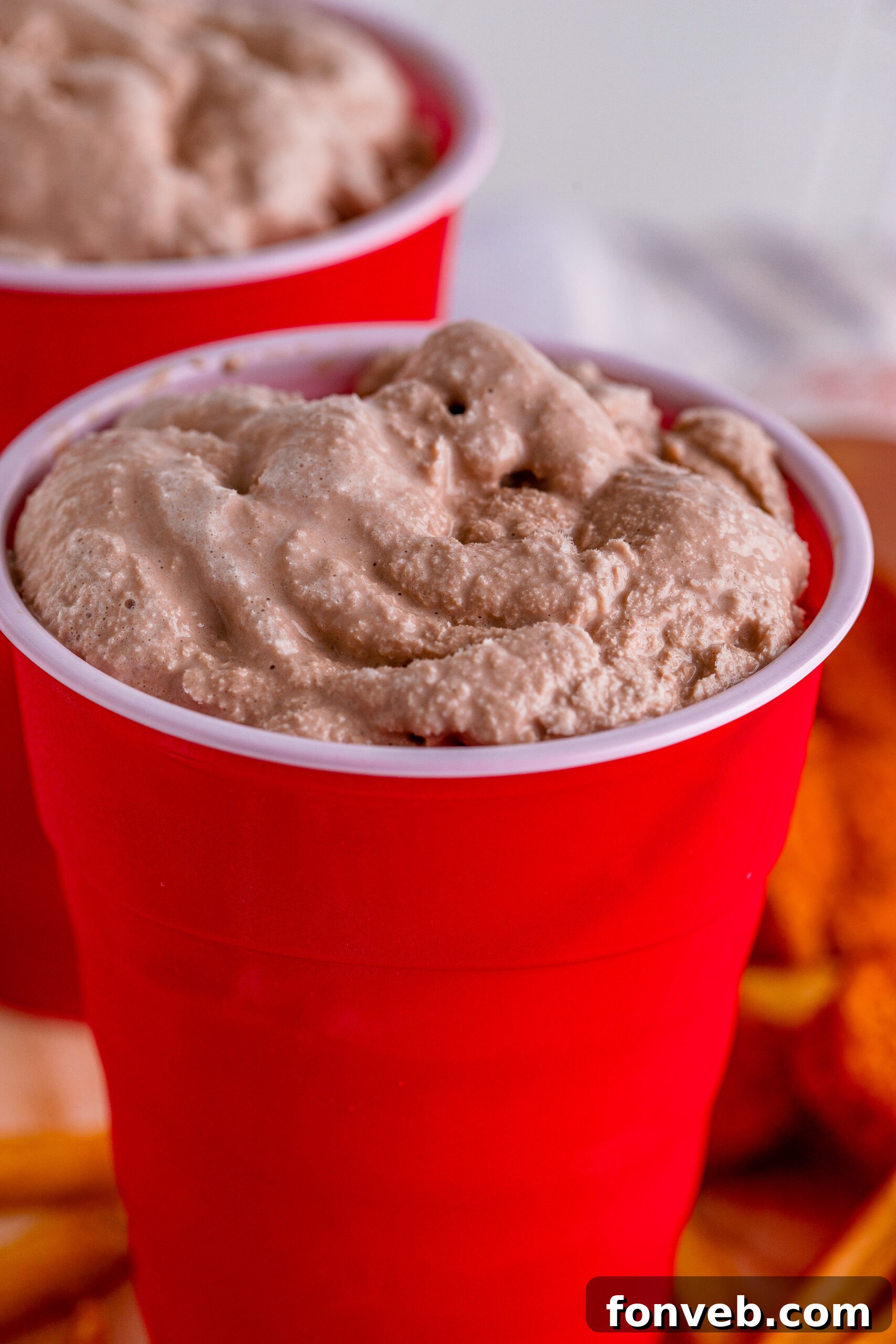 Close-up side view of a homemade Wendy's Frosty in a red solo cup, showing its thick texture