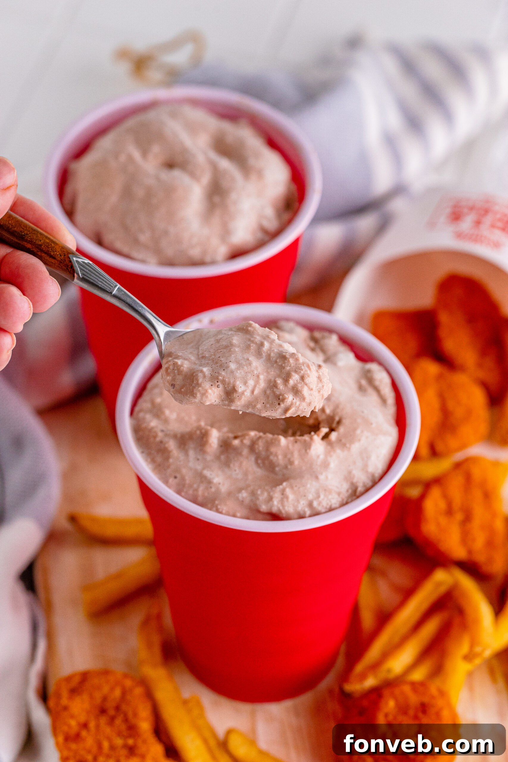 Close-up of a spoon scooping homemade Wendy's Frosty from a red solo cup