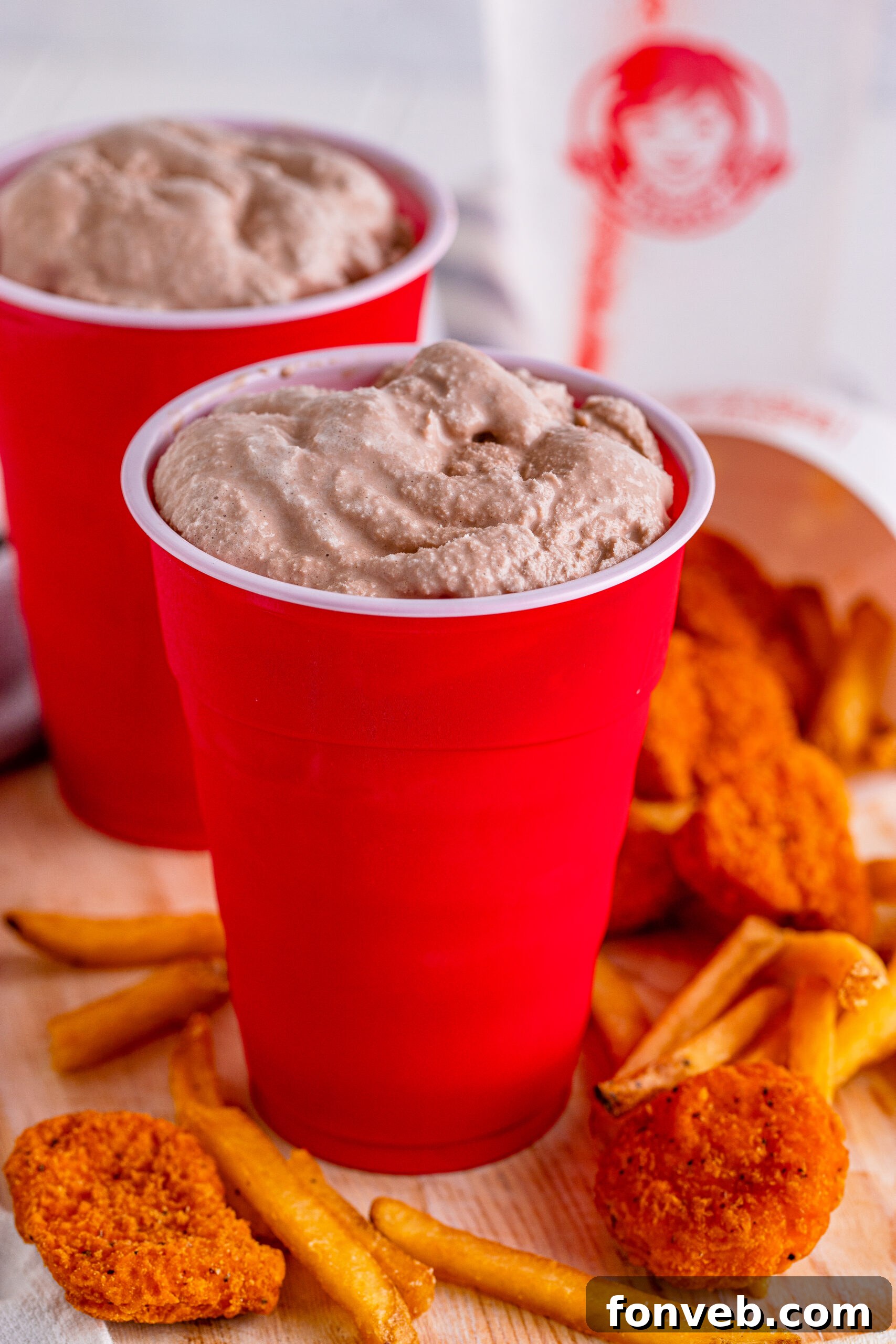 Homemade Wendy's Frosty in a red solo cup, served with chicken nuggets and fries for dipping