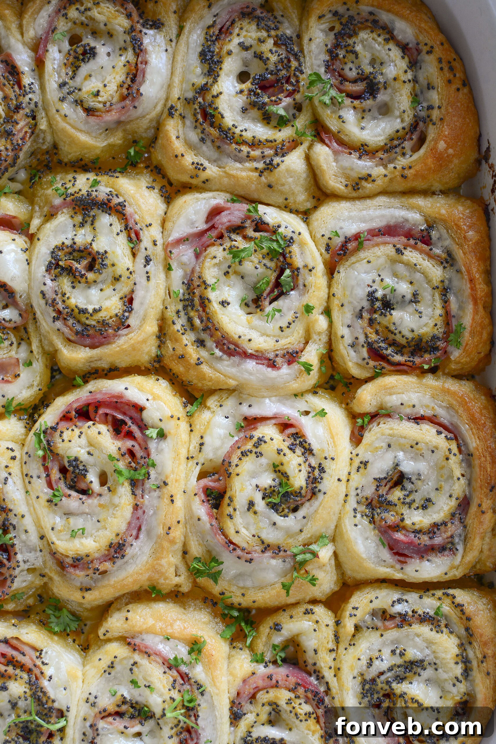 Ham and Cheese Pinwheels in a white baking dish overhead photo