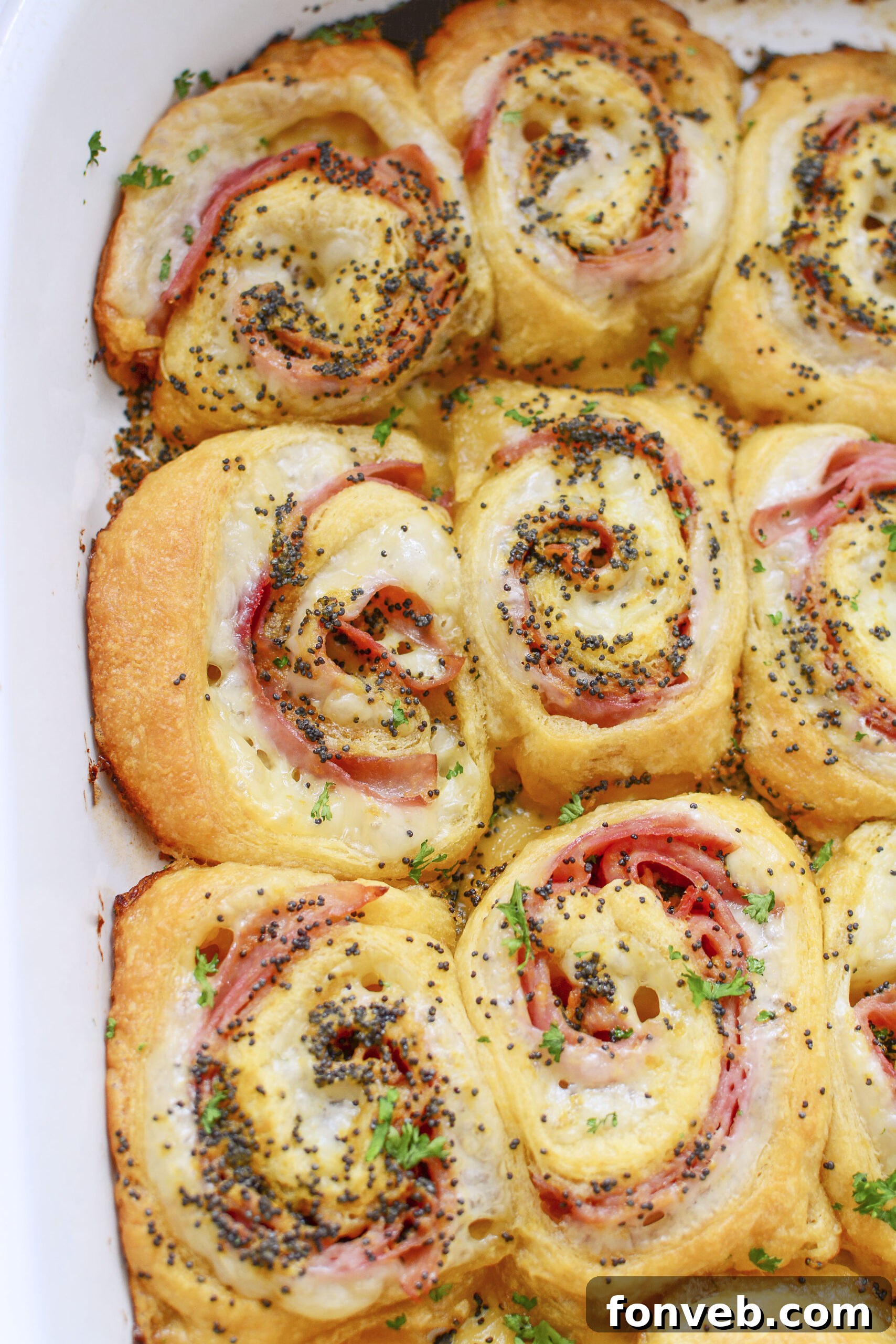 Ham and Cheese Pinwheels in a white baking dish overhead shot