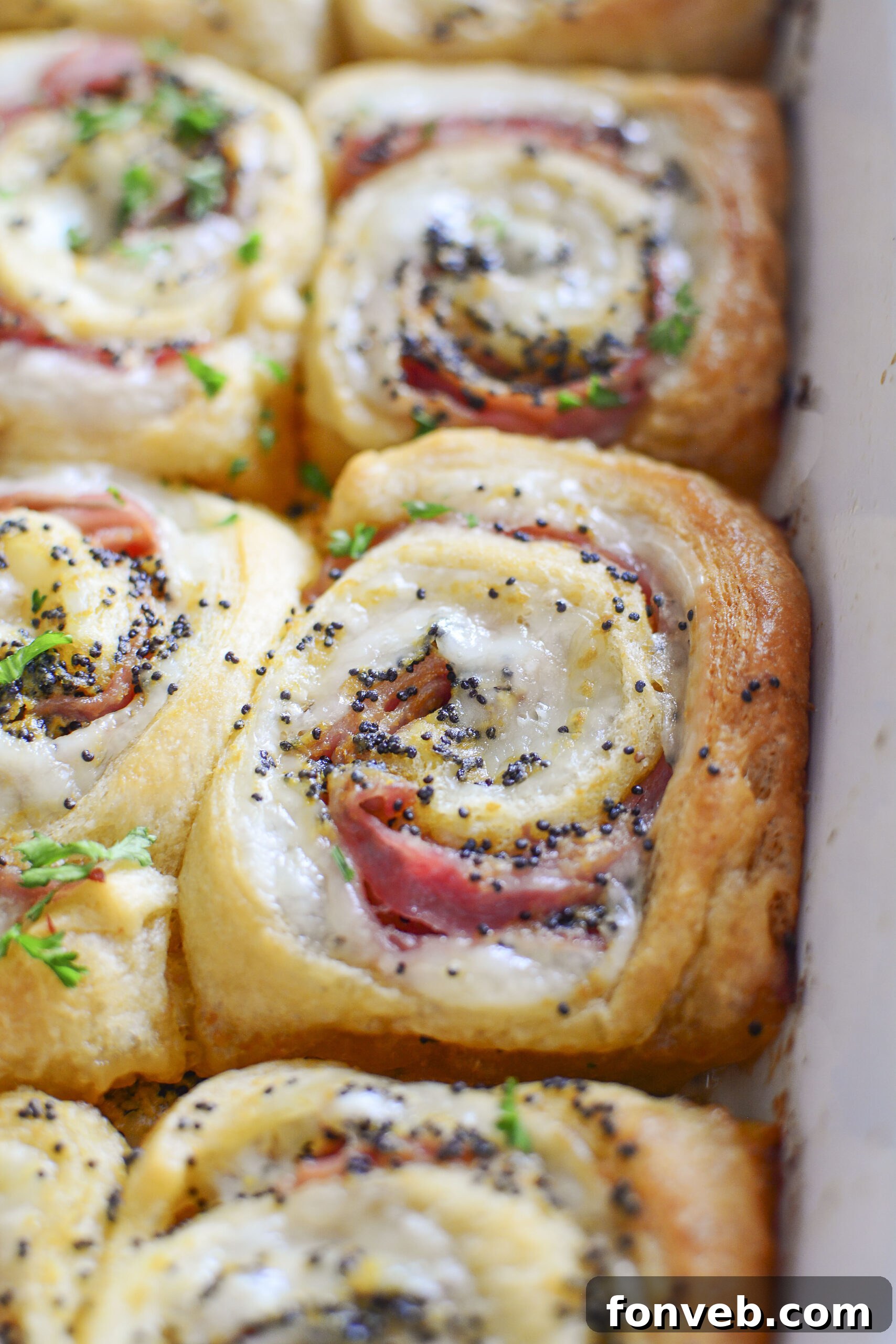 Ham and Cheese Pinwheels in a white baking dish close up shot
