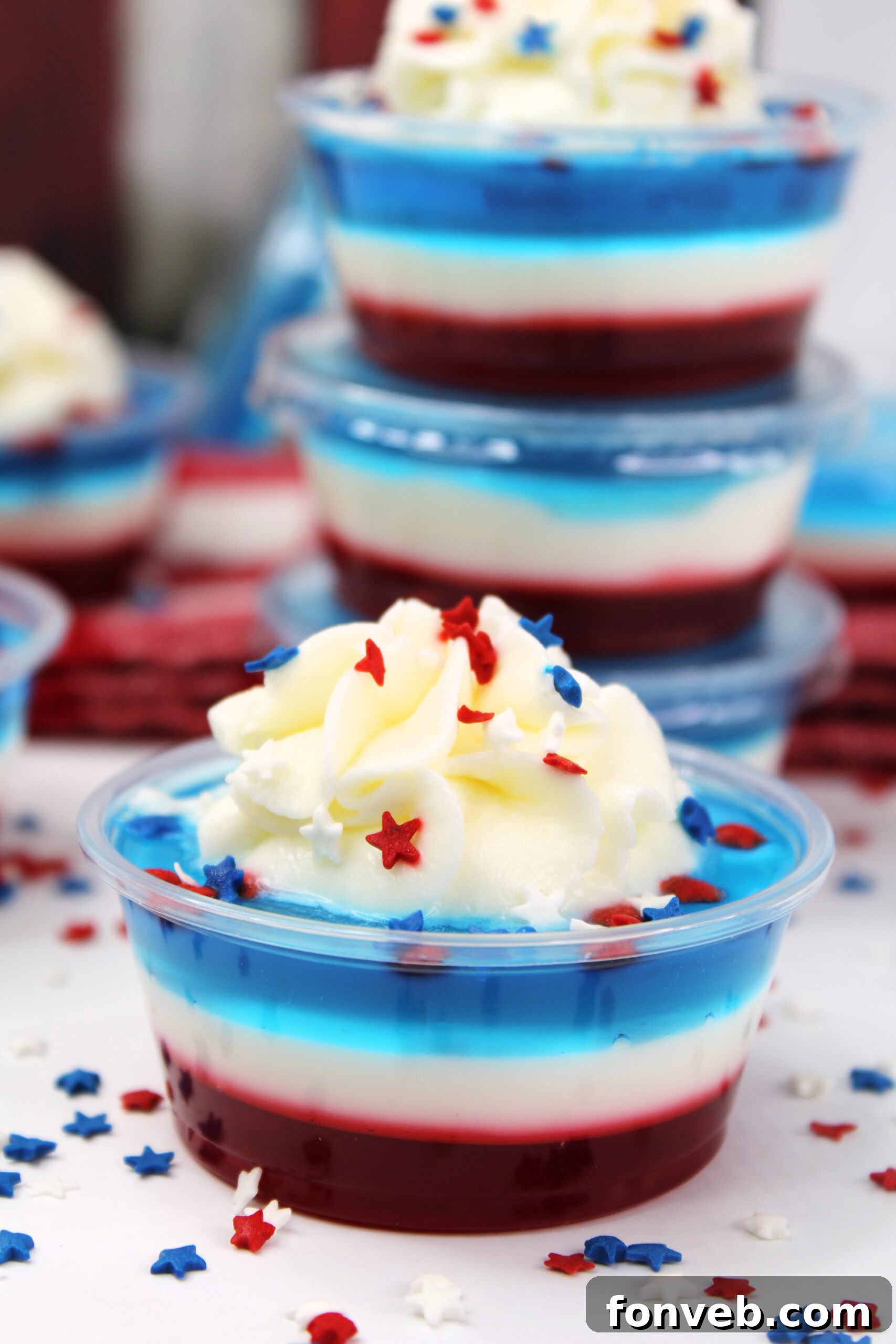 Bomb Pop Jello Shot layered red, white & blue topped with whipped cream
