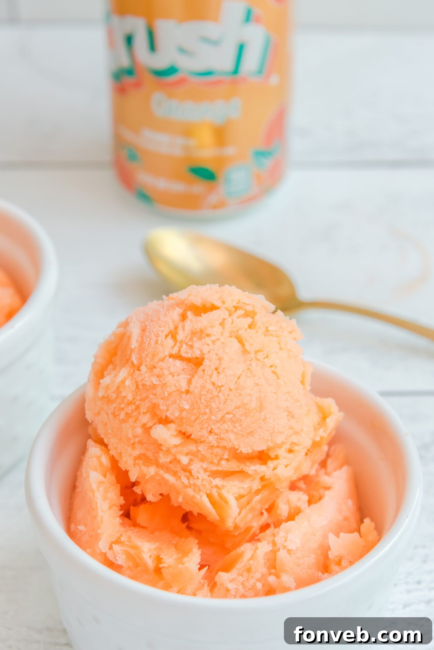 Orange Crush Sherbet in a pristine white bowl, showcasing its bright orange color and smooth texture
