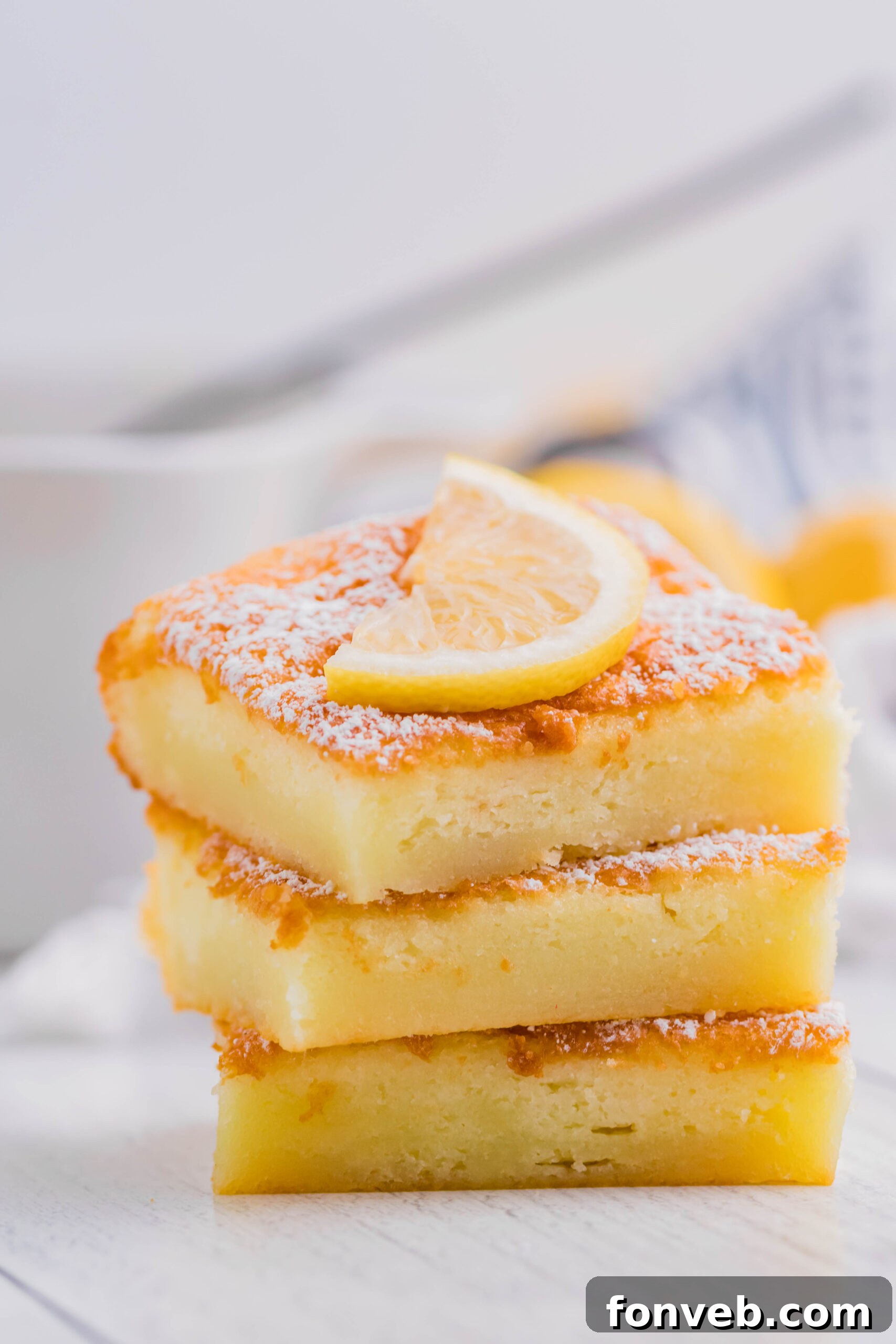 2 Ingredient Lemon Bars stacked on a white plate