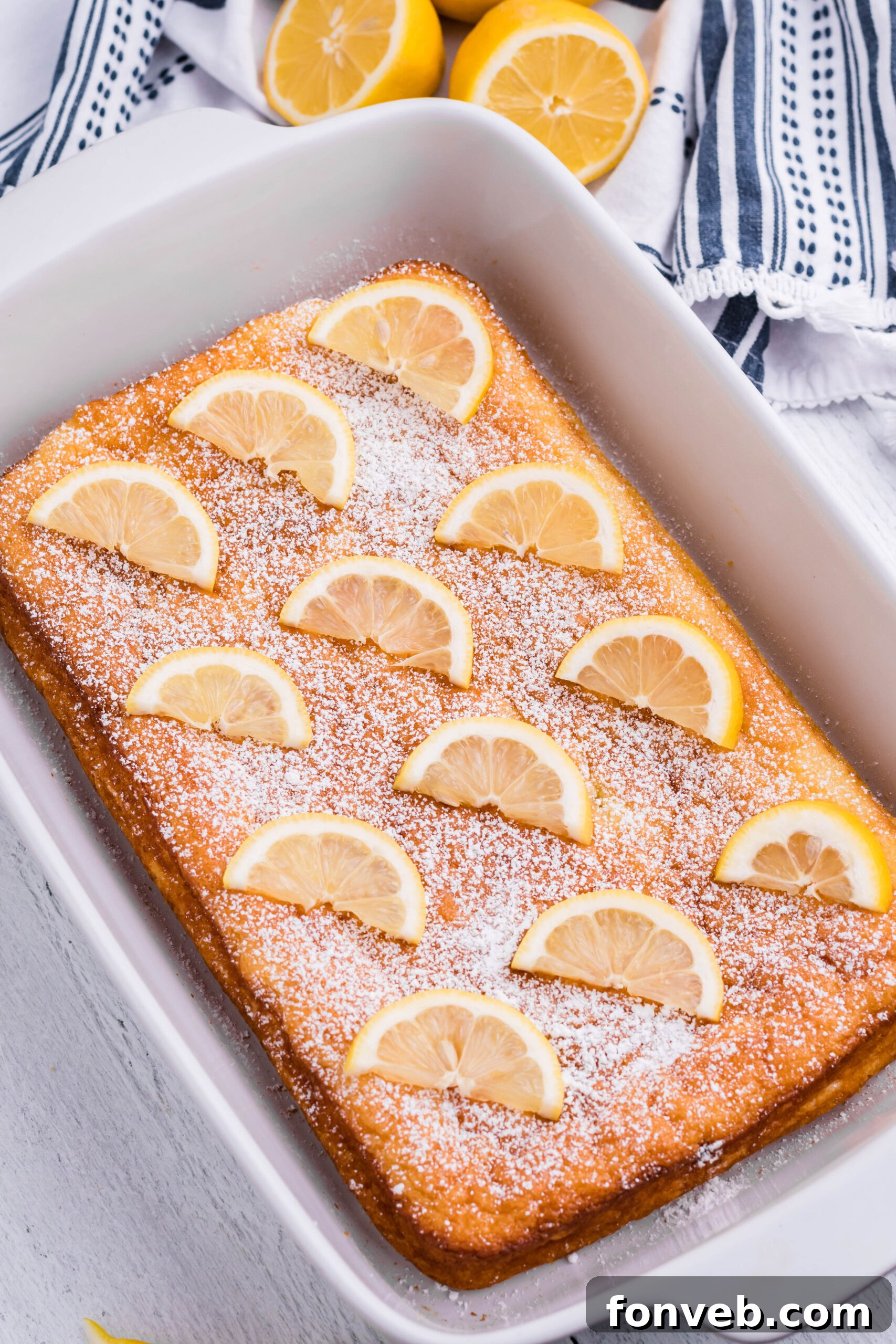2 Ingredient Lemon Bars uncut in a white baking pan