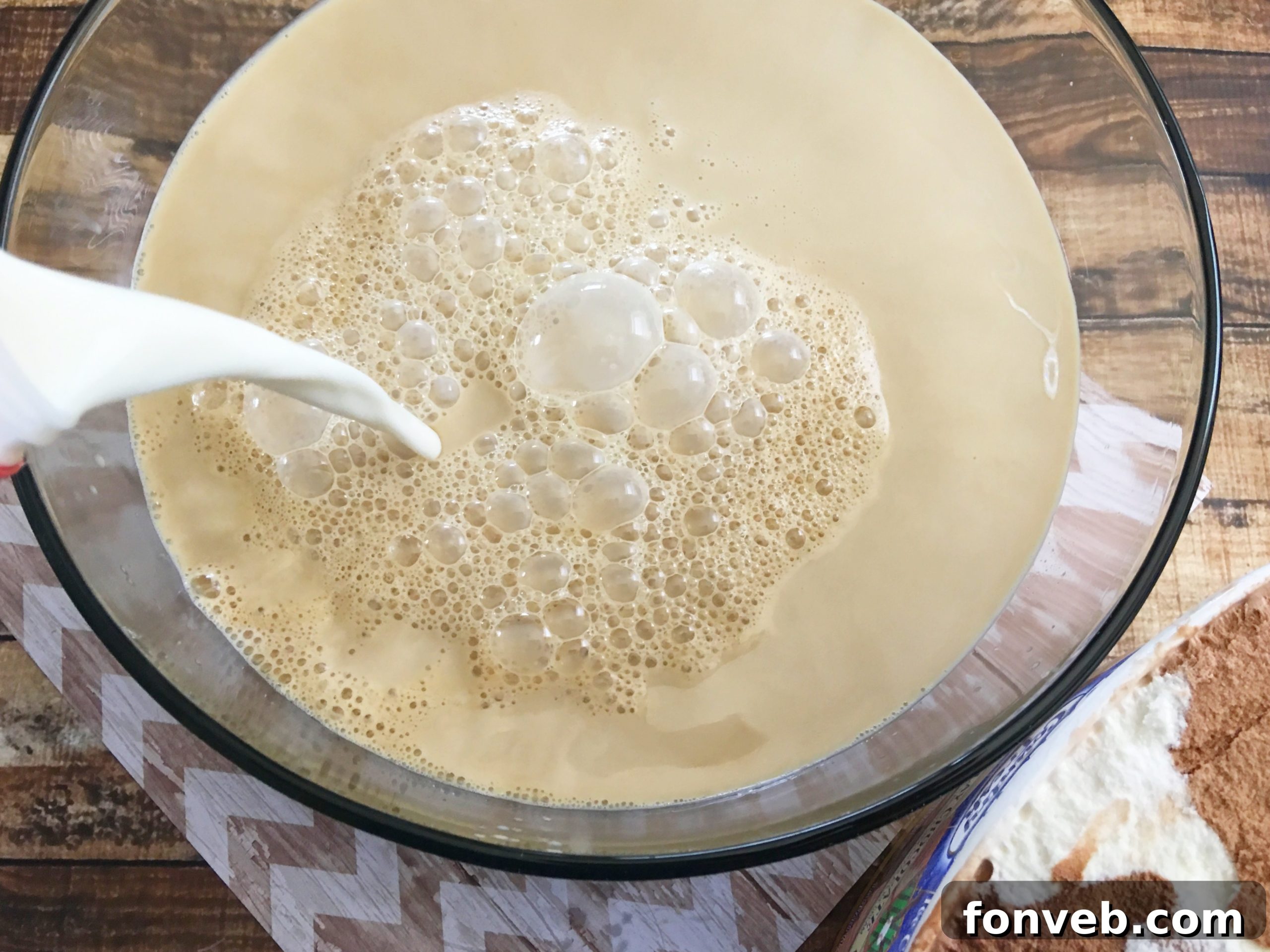 Pouring a creamy coffee creamer into the punch