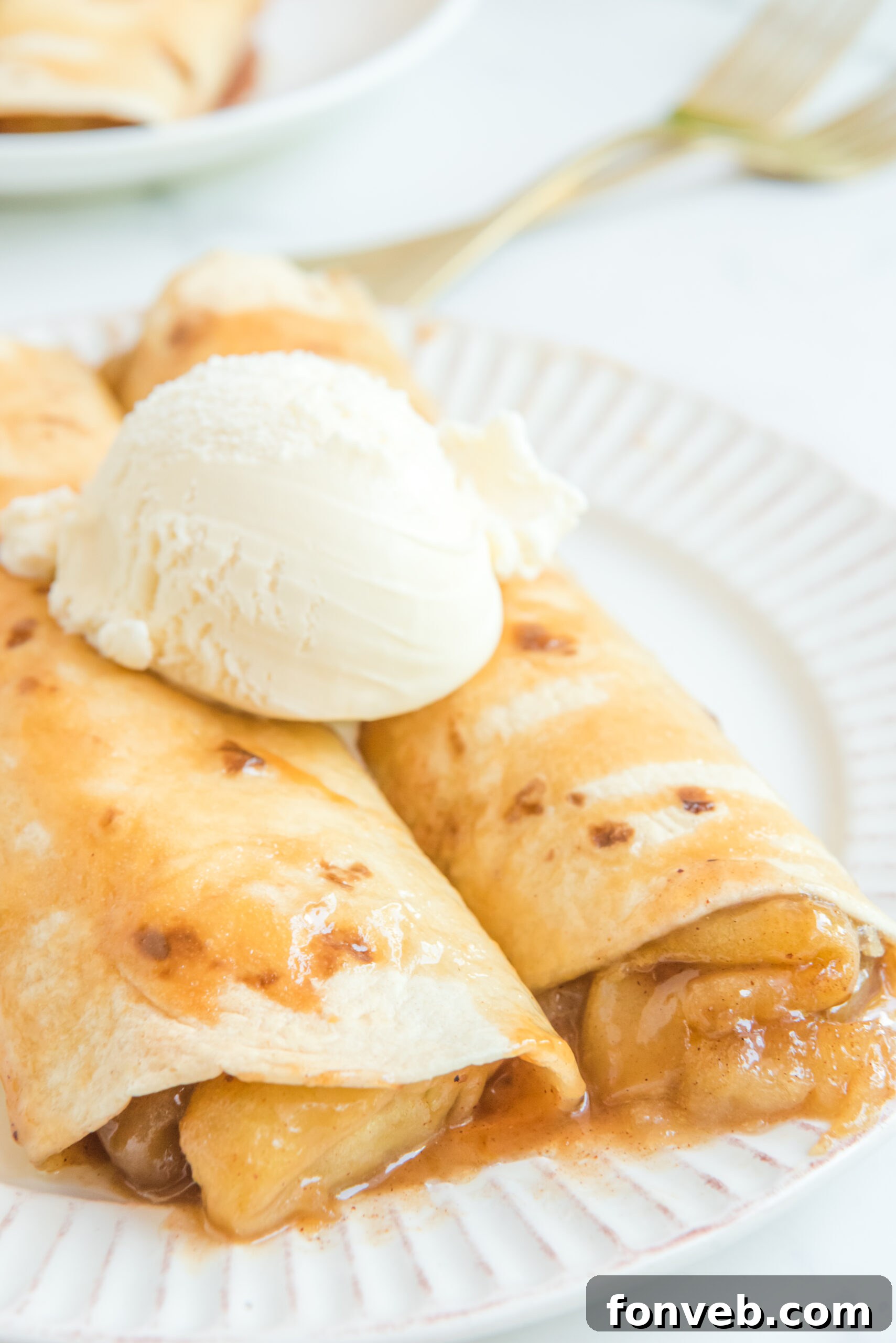 Apple Pie Enchiladas topped with vanilla ice cream
