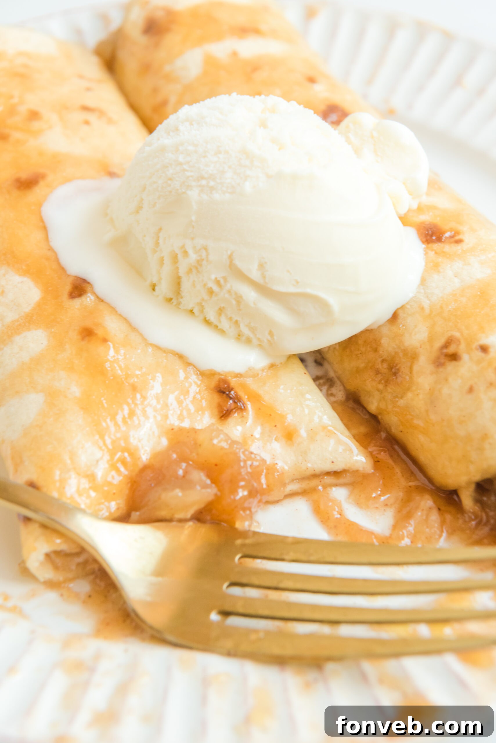 Apple Pie Enchiladas topped with vanilla ice cream