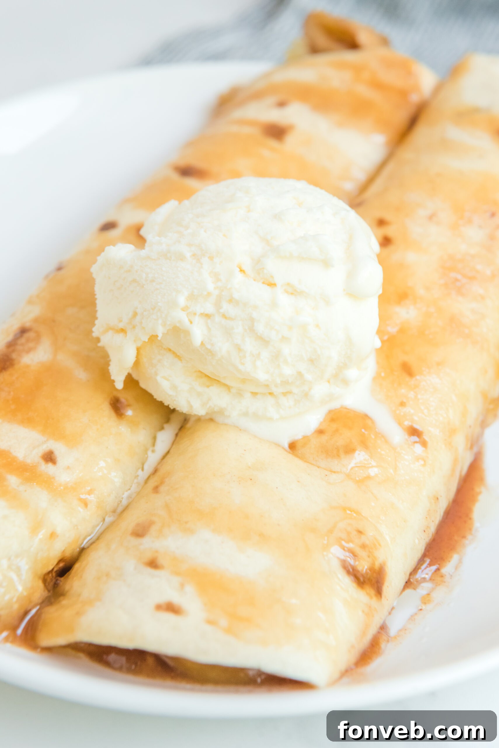Apple Pie Enchiladas topped with vanilla ice cream overhead shot