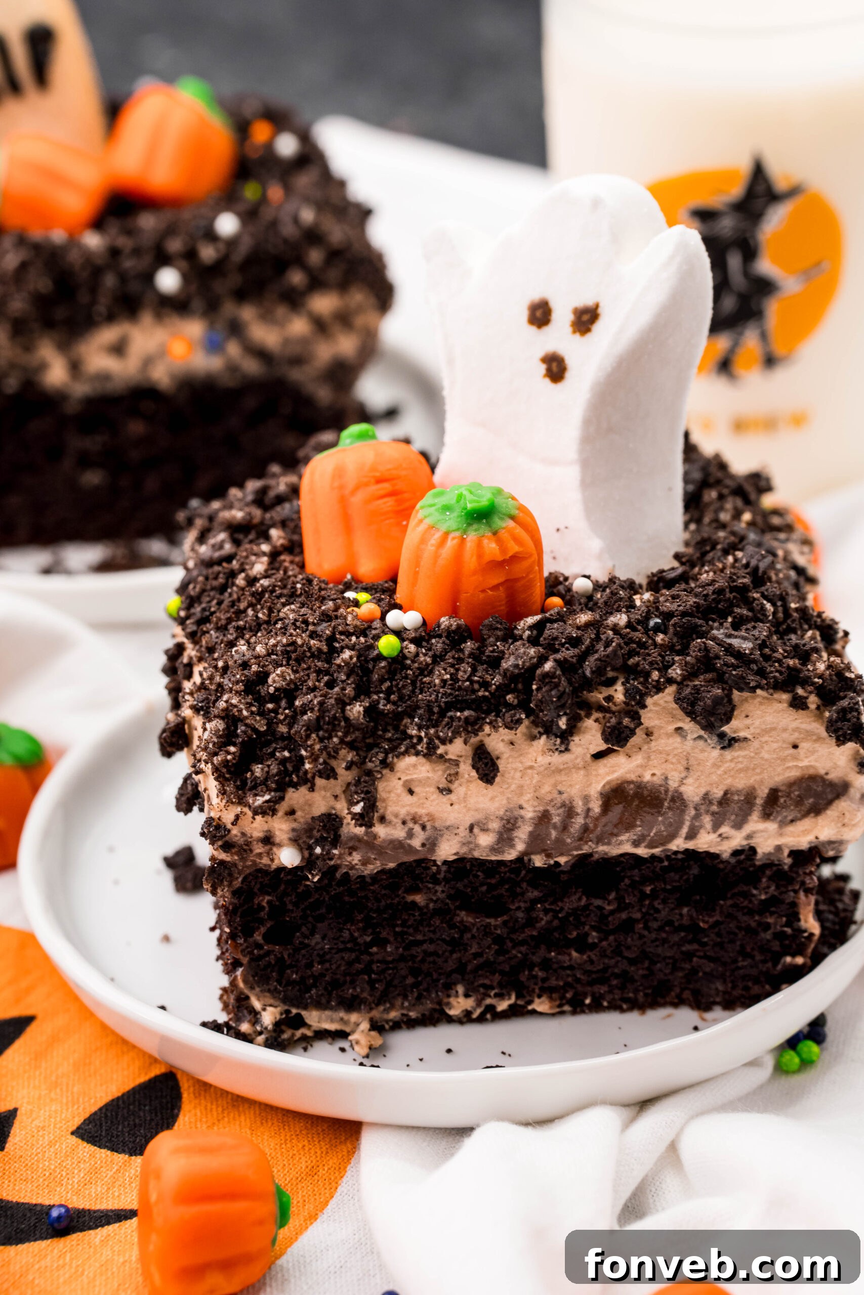 A vibrant and festive slice of Halloween Dirt Cake, beautifully arranged on a white plate, capturing its spooky charm and delicious appeal.