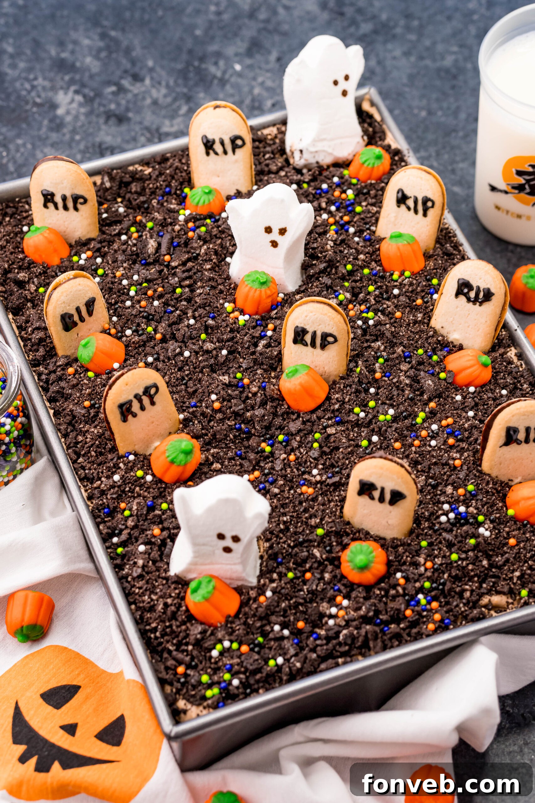 An unadorned Halloween Dirt Cake, freshly baked and ready for its spooky transformation, sitting invitingly in a silver baking pan.
