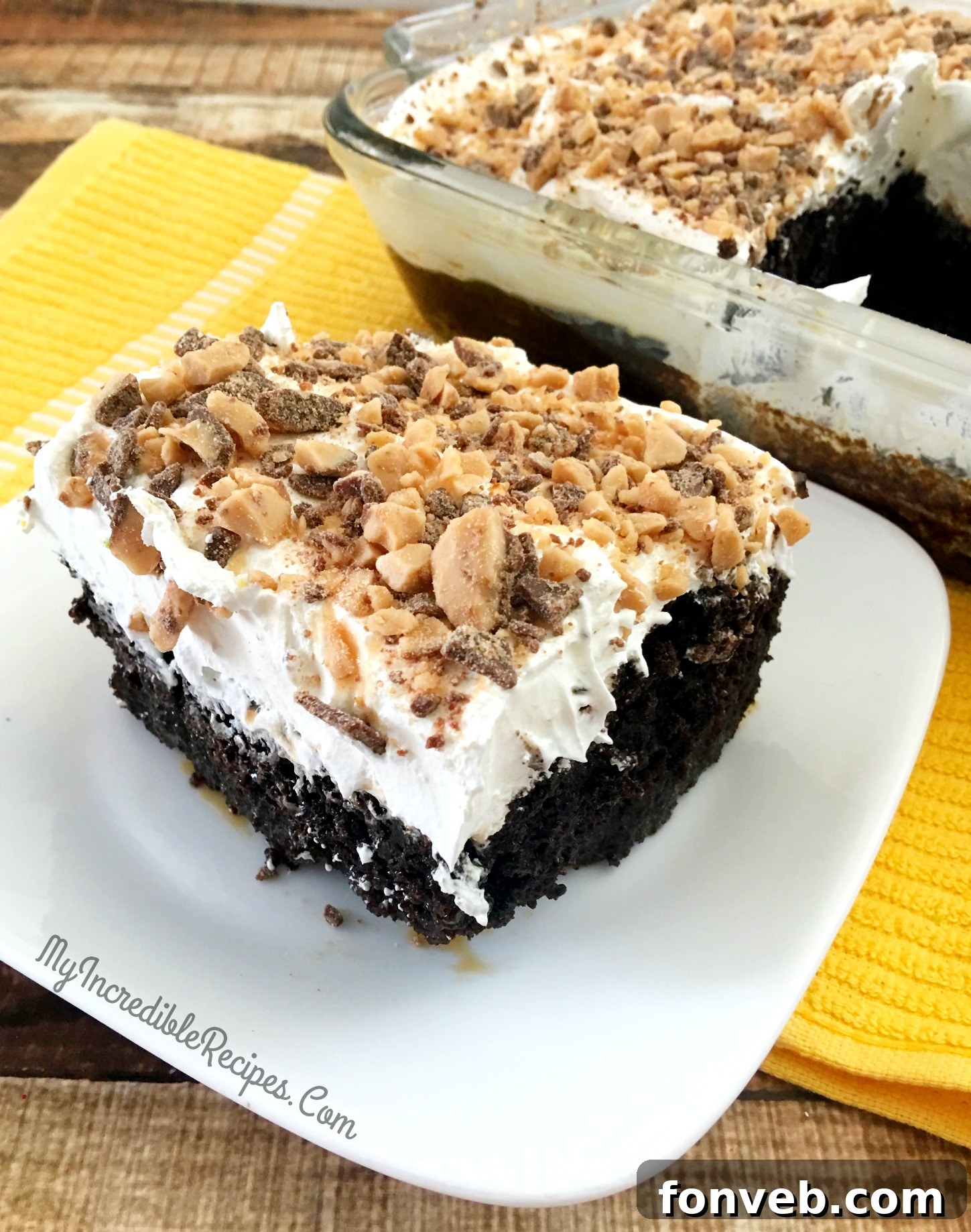 Rich and gooey caramel pouring over the poked chocolate cake