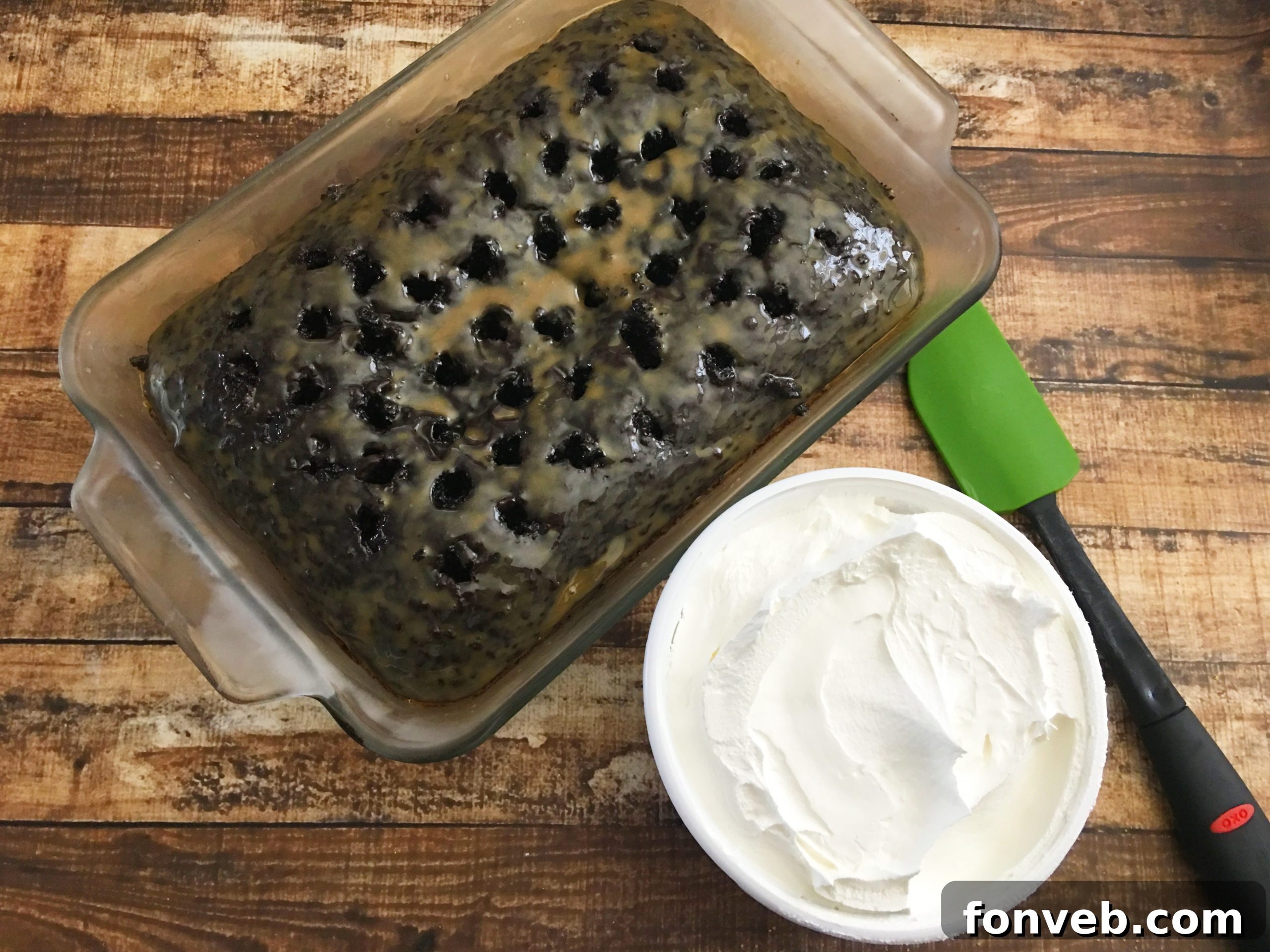 Adding Heath toffee bits as a final topping to the cake