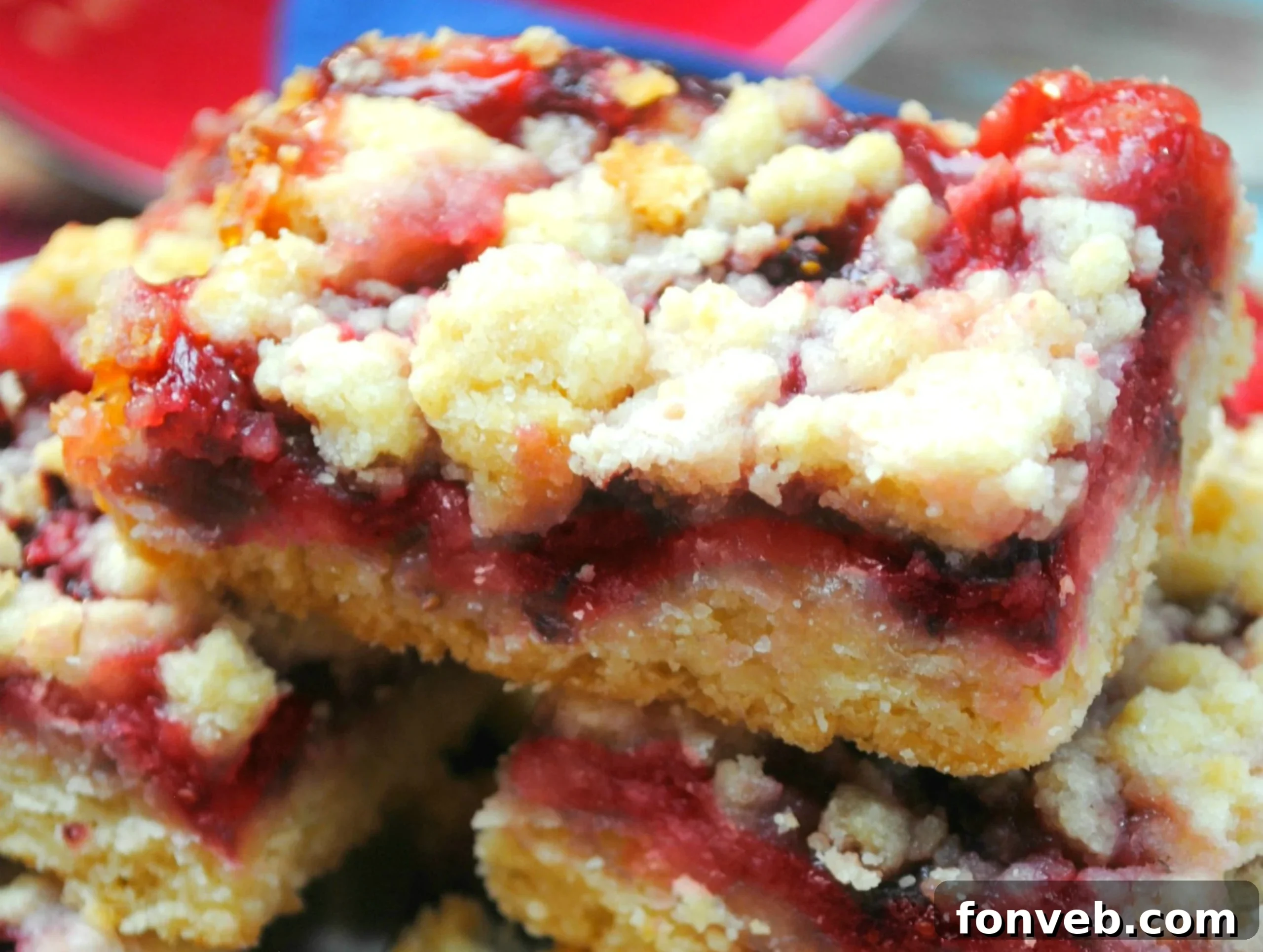 Jammy Raspberry Oat Bars 2 Close-up of baked Raspberry Crumble Bars, golden brown and glistening with raspberry filling, cooling on a rack.