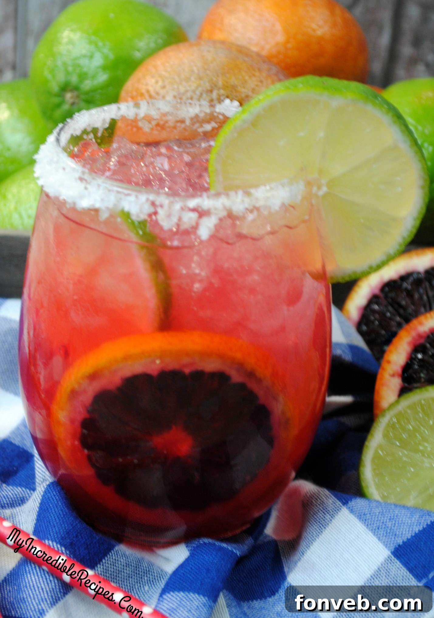 A close-up view of a Blood Orange Margarita glass, showcasing its perfectly sugared rim and a fresh blood orange slice garnish.