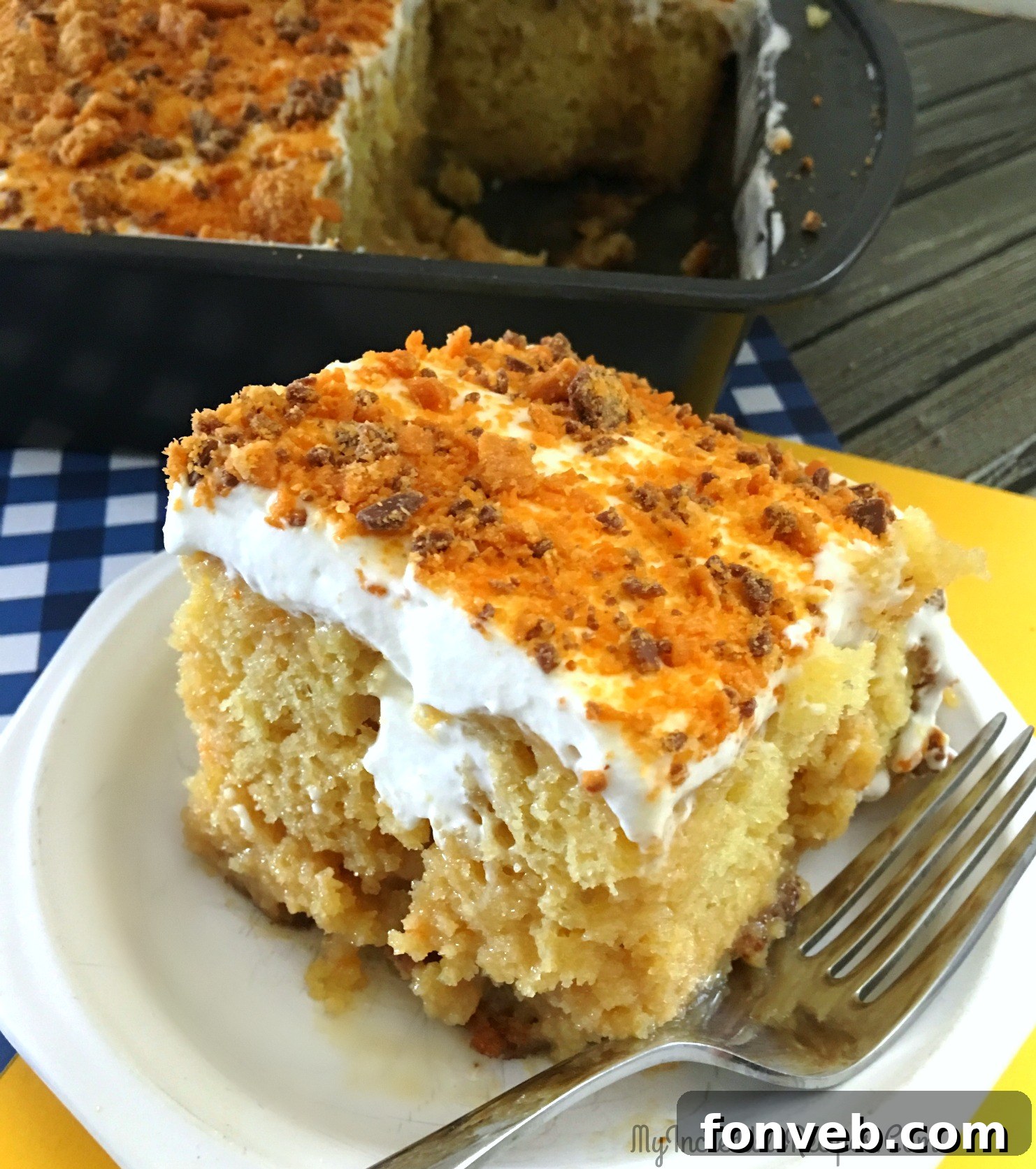 The full Butterfinger Extasy Cake, beautifully decorated with whipped cream and a generous sprinkling of crushed Butterfinger.