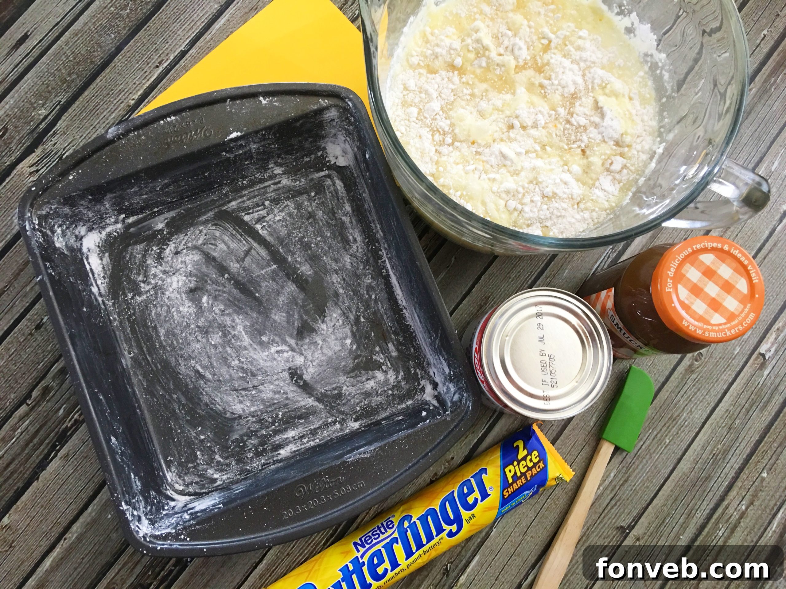 Close-up of a vibrant yellow cake with a perfectly golden crust, ready for the next steps.