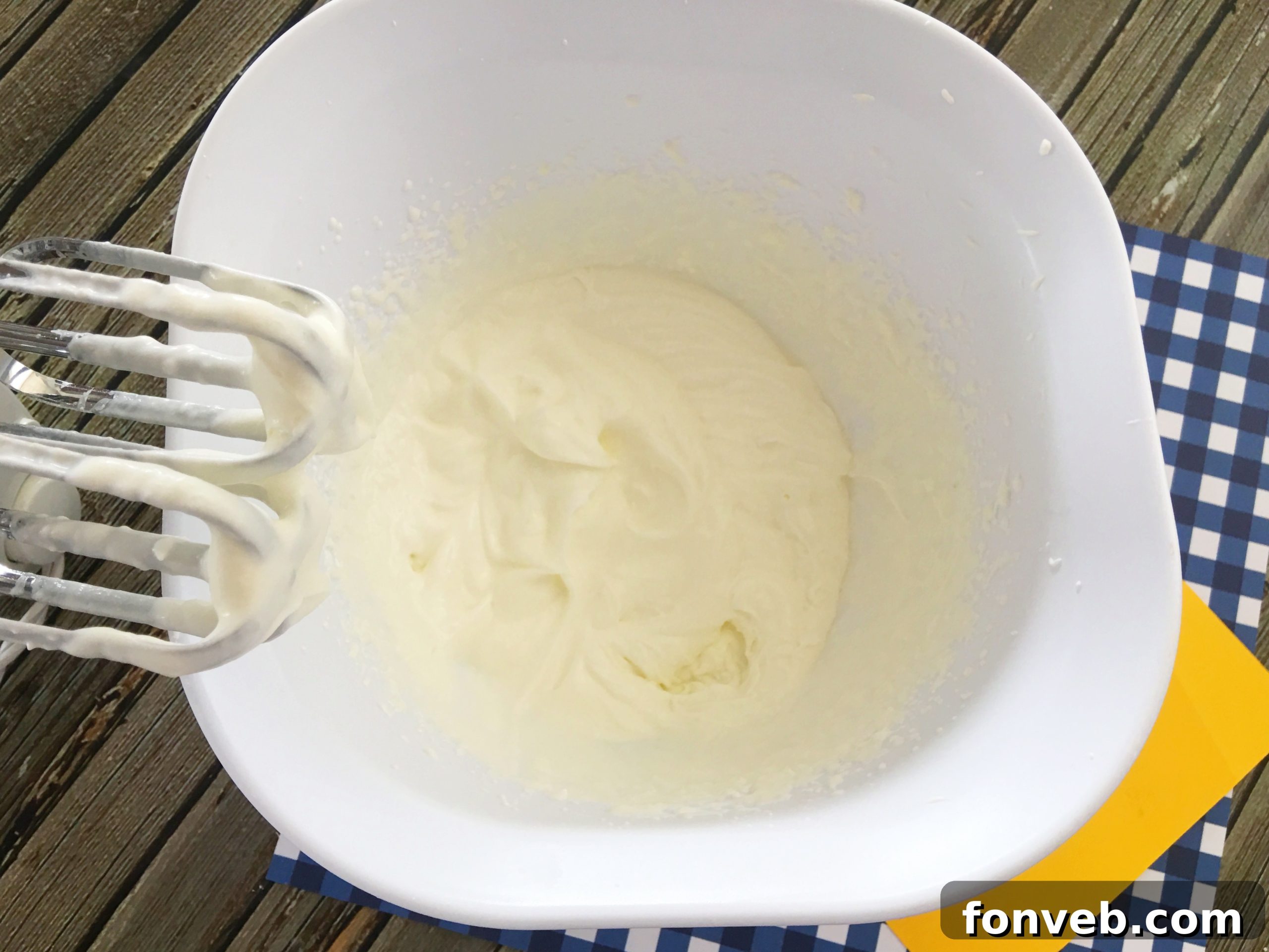 A baked yellow cake in a pan, showcasing its moist texture before the poke cake treatment.