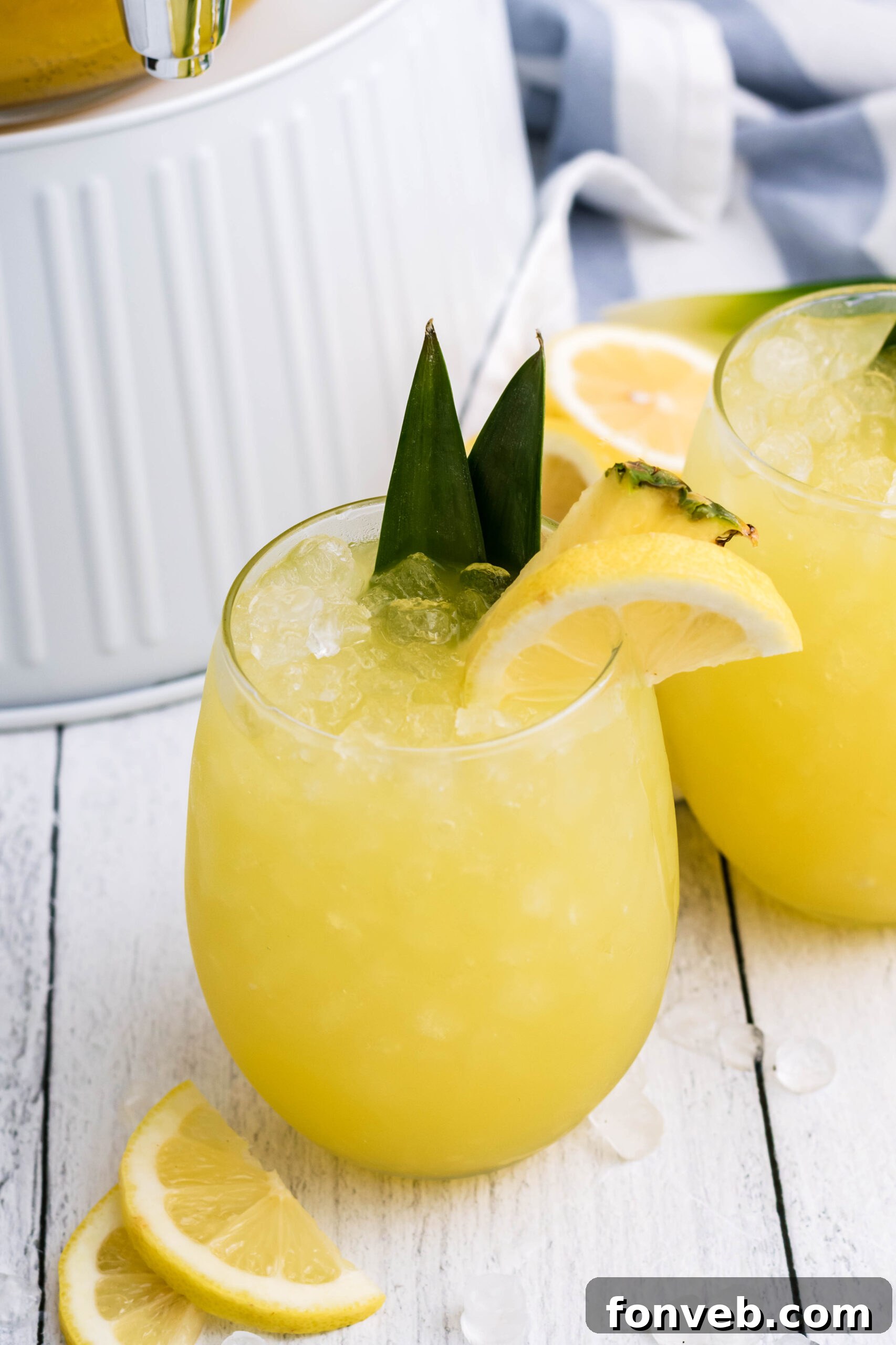 Overhead shot of Pineapple Lemonade in a clear glass on a rustic wooden surface, highlighting its freshness