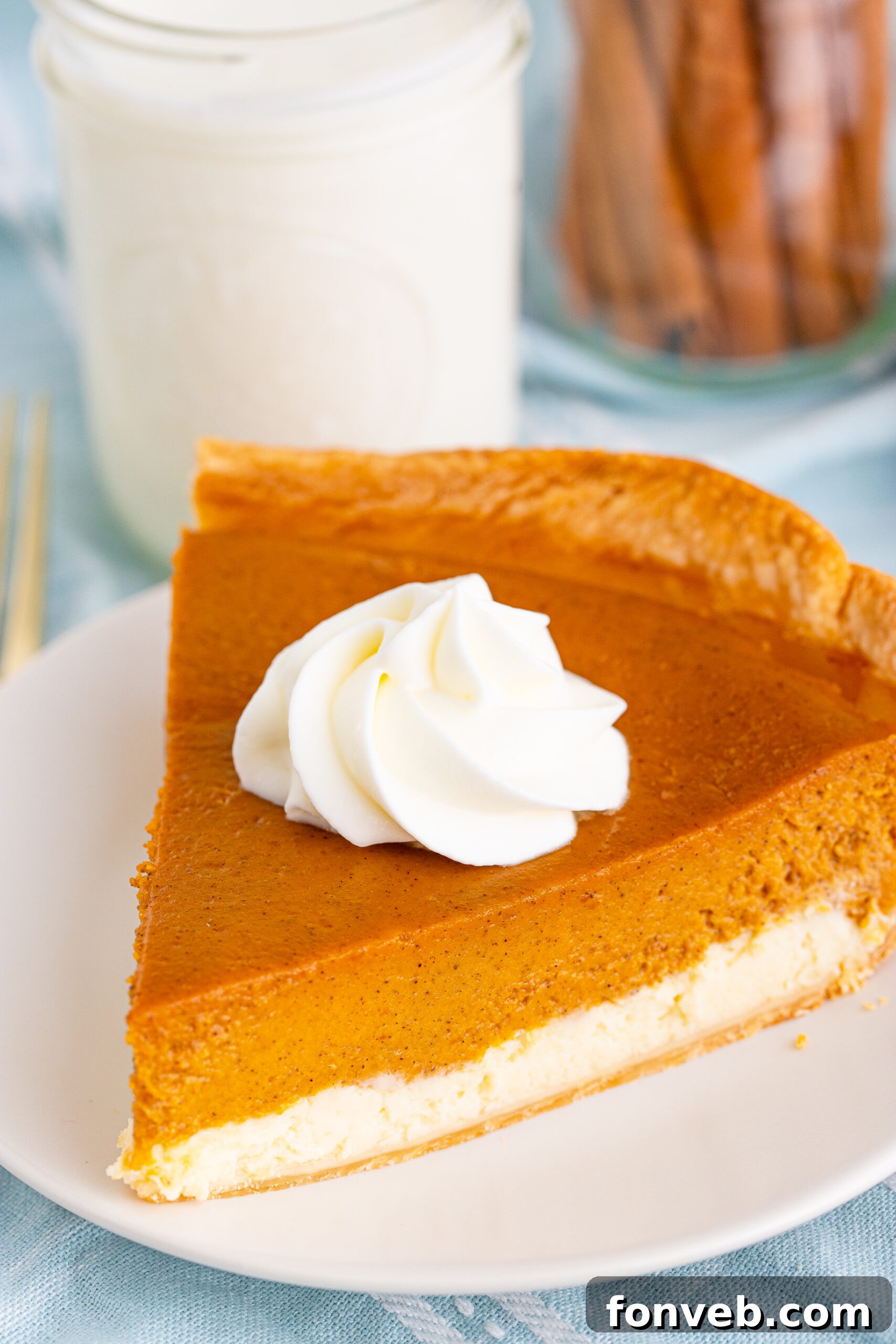 A final close-up shot of a perfect slice of Pumpkin Pie Cheesecake on a white plate
