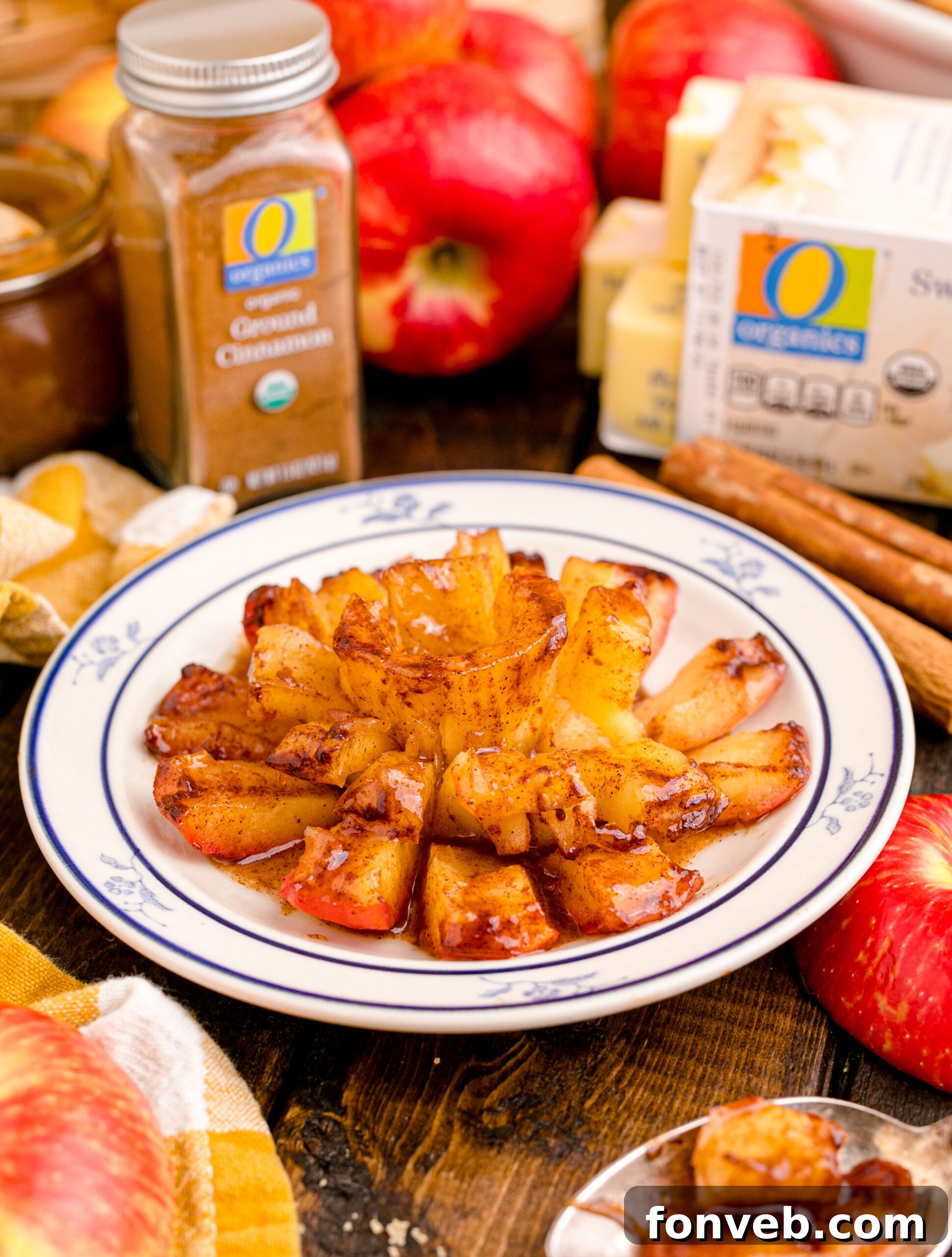 Oven Baked Bloomin Apples on a white plate on a wood table