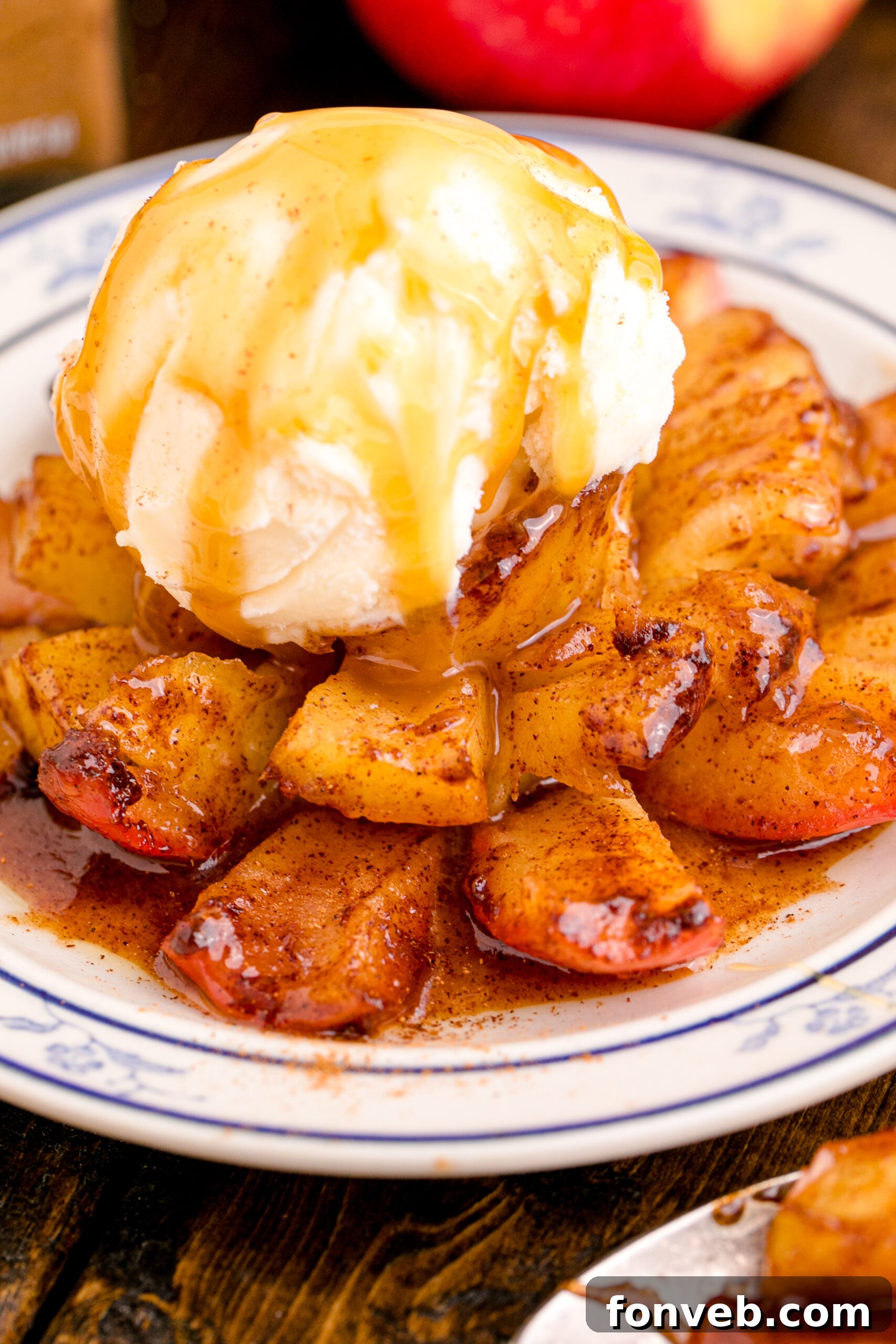 Oven Baked Bloomin Apples on a white plate topped with ice cream and caramel sauce