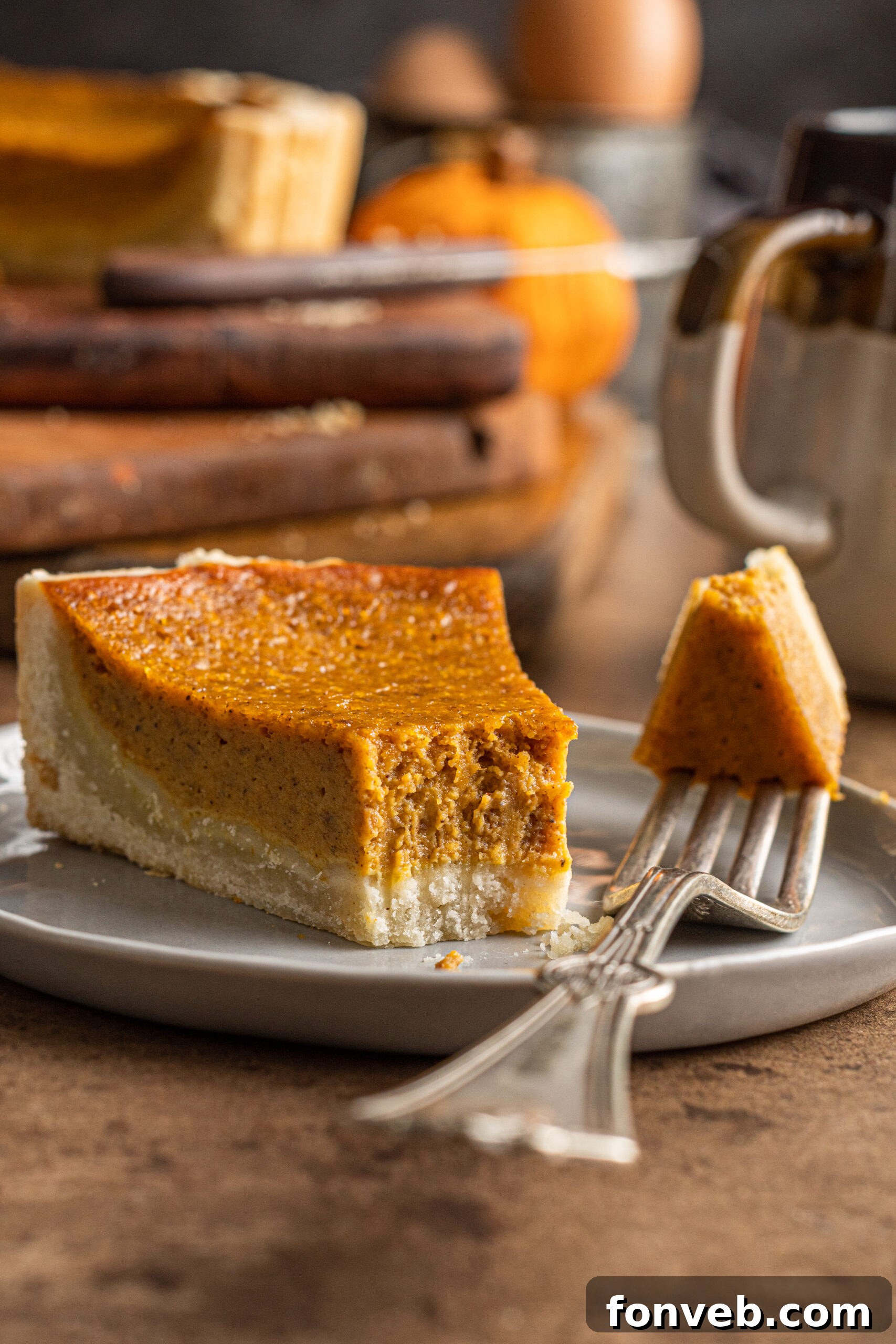 Close-up of a slice of homemade Pumpkin Pie Tart with a bite taken out, showcasing its creamy texture