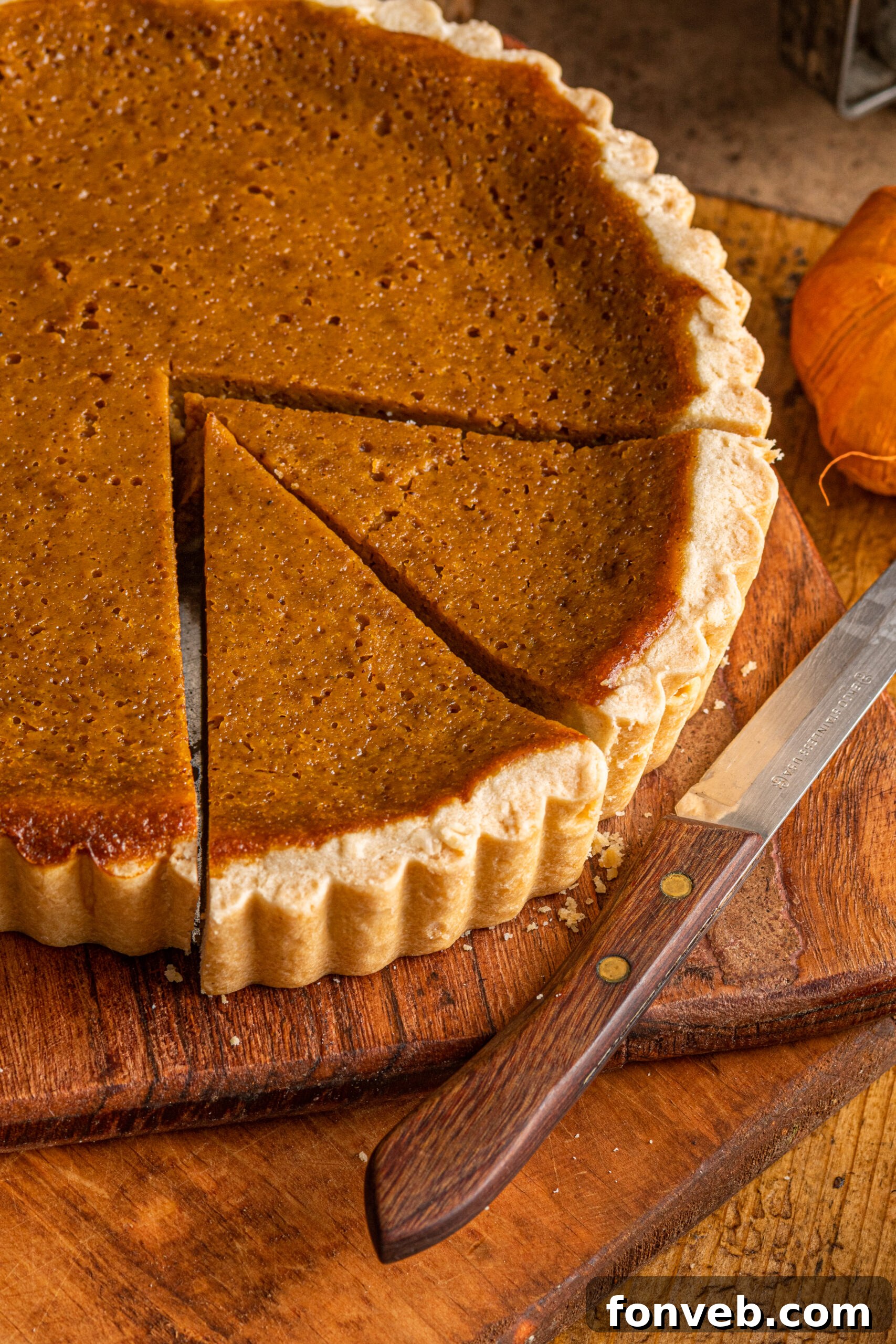 Overhead shot of the full Pumpkin Pie Tart on a rustic wooden cutting board