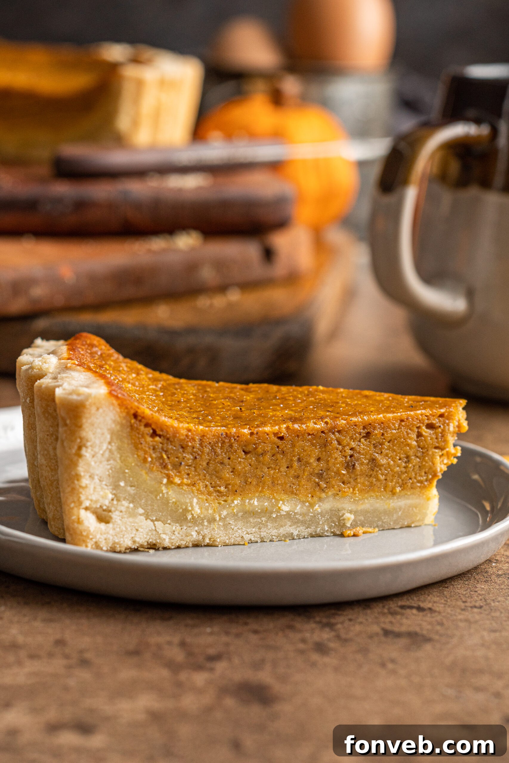 A single slice of Pumpkin Pie Tart on a gray plate, ready to be enjoyed
